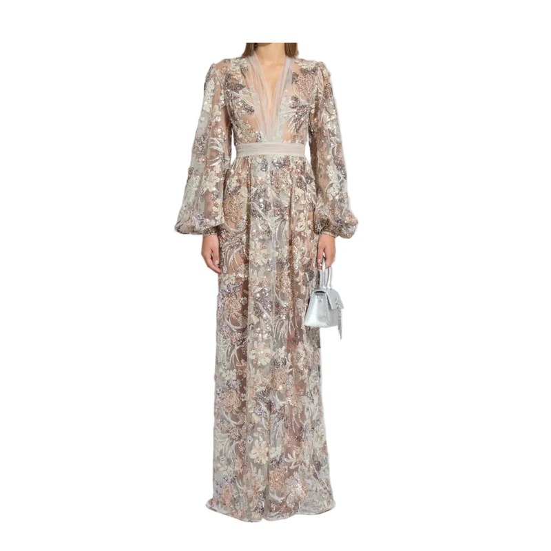Woman wearing a floral dress with long sleeves on a white background