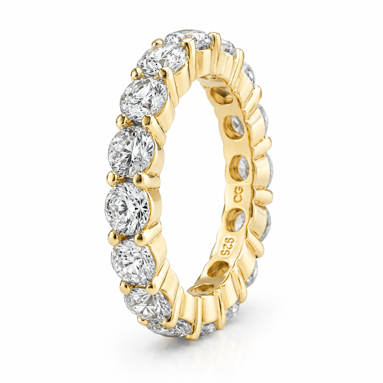Gold-toned eternity ring with a full circle of clear, round cubic zirconia stones in a four-prong setting.