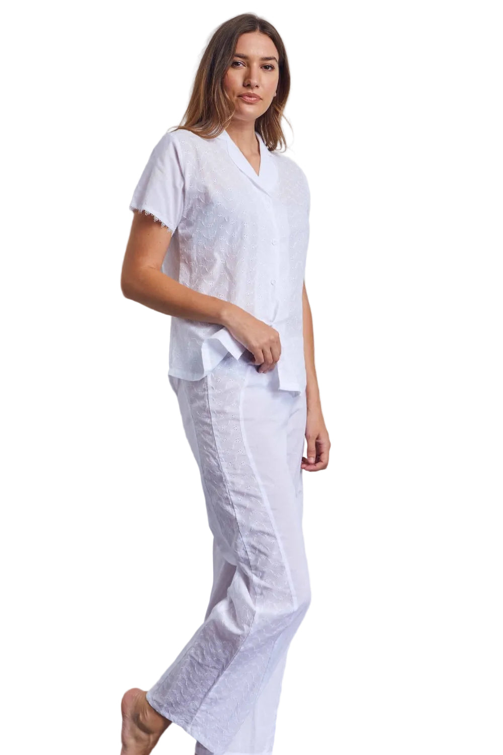 White short-sleeved button-up pyjama top and matching long trousers with floral broderie anglaise detailing.