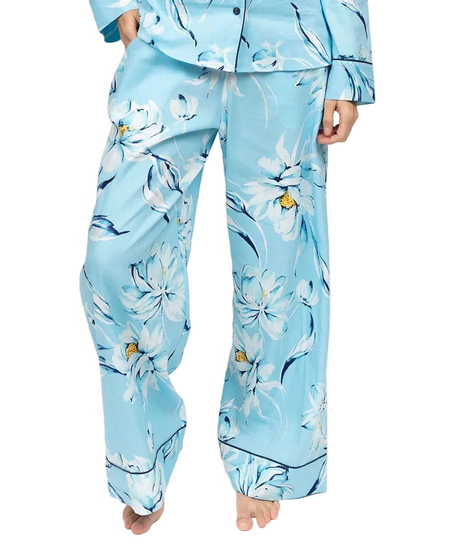 Light blue wide-leg woven trousers with white and dark blue floral pattern and dark blue piping at the hem.