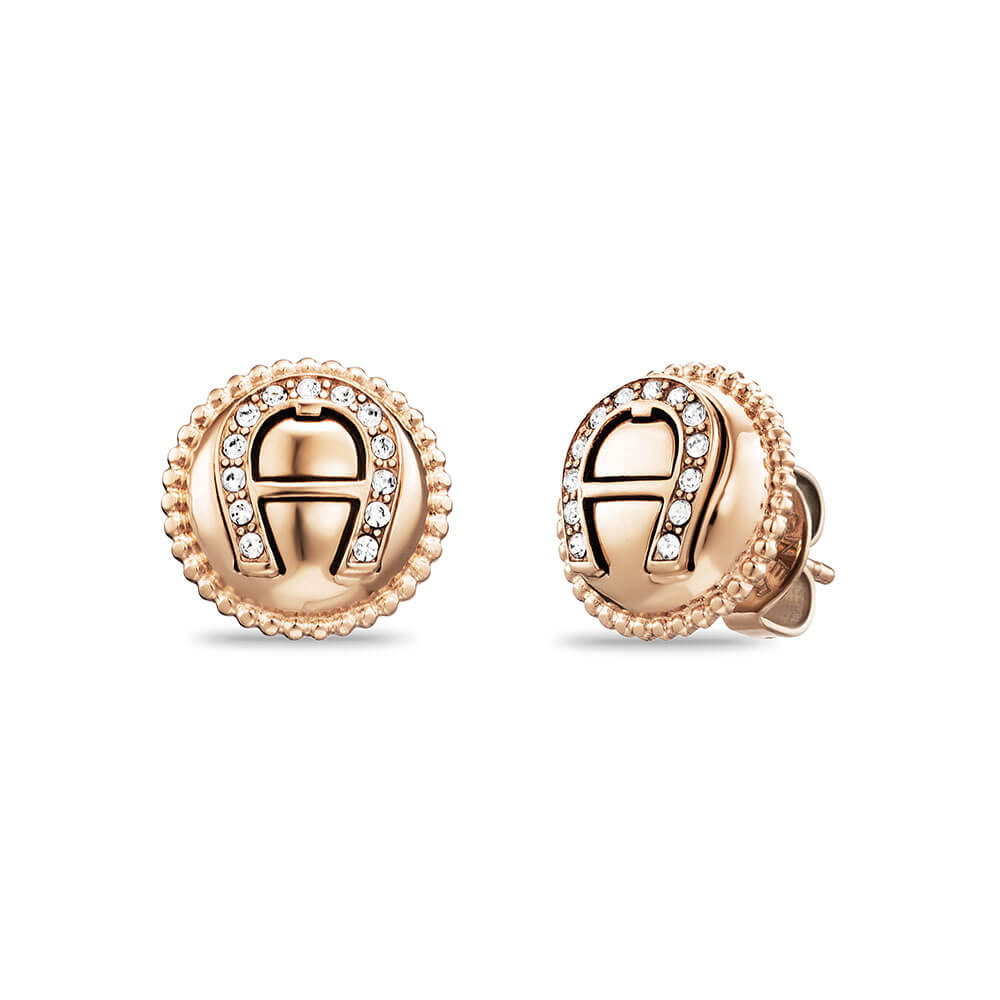 Pair of rose gold-toned Aigner stud earrings with the 'A' logo partially embellished with clear stones and a beaded edge.