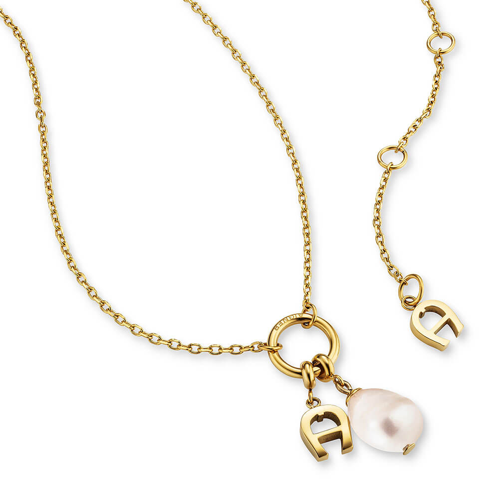 Gold-toned Aigner short necklace with a fine chain, a central ring, two 'A' initial charms, and a baroque pearl pendant.