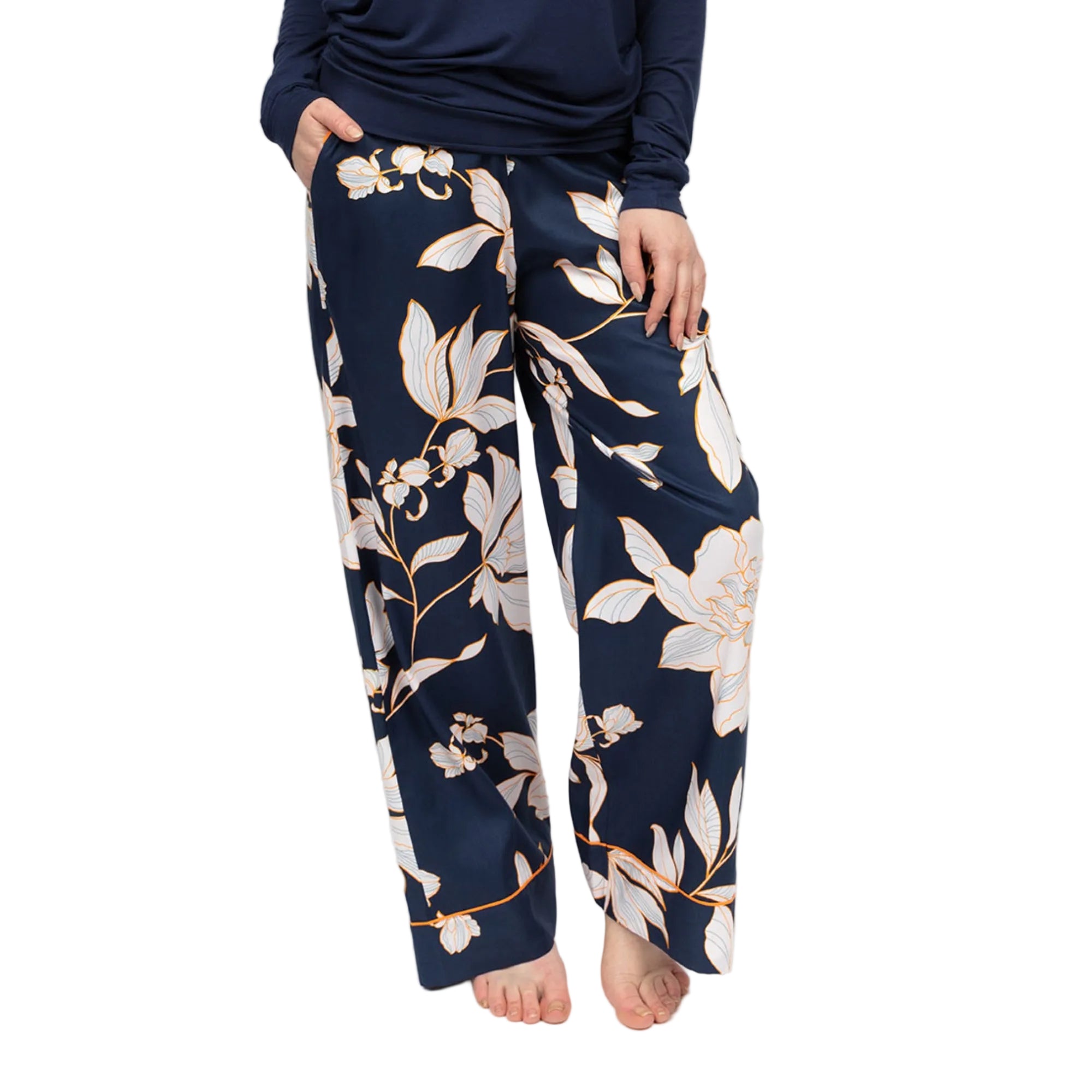 Navy wide leg pyjama bottoms with white and auburn floral print, featuring side pockets and piped hems.
