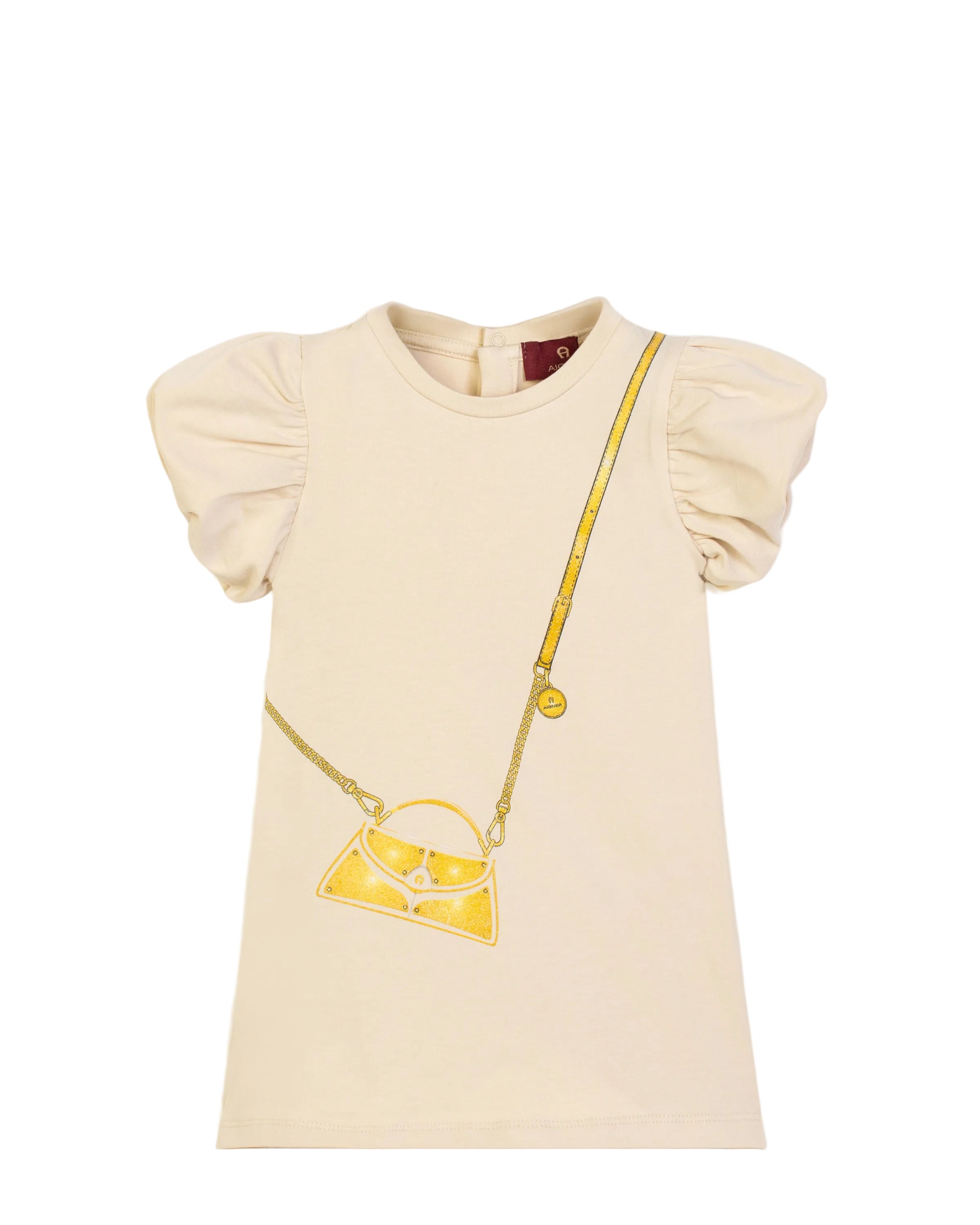 Front view flat-lay studio shot of the Aigner Kids baby girls cream short-sleeve dress, showcasing its dramatic gathered puff sleeves and central golden-yellow crossbody handbag graphic illustration.