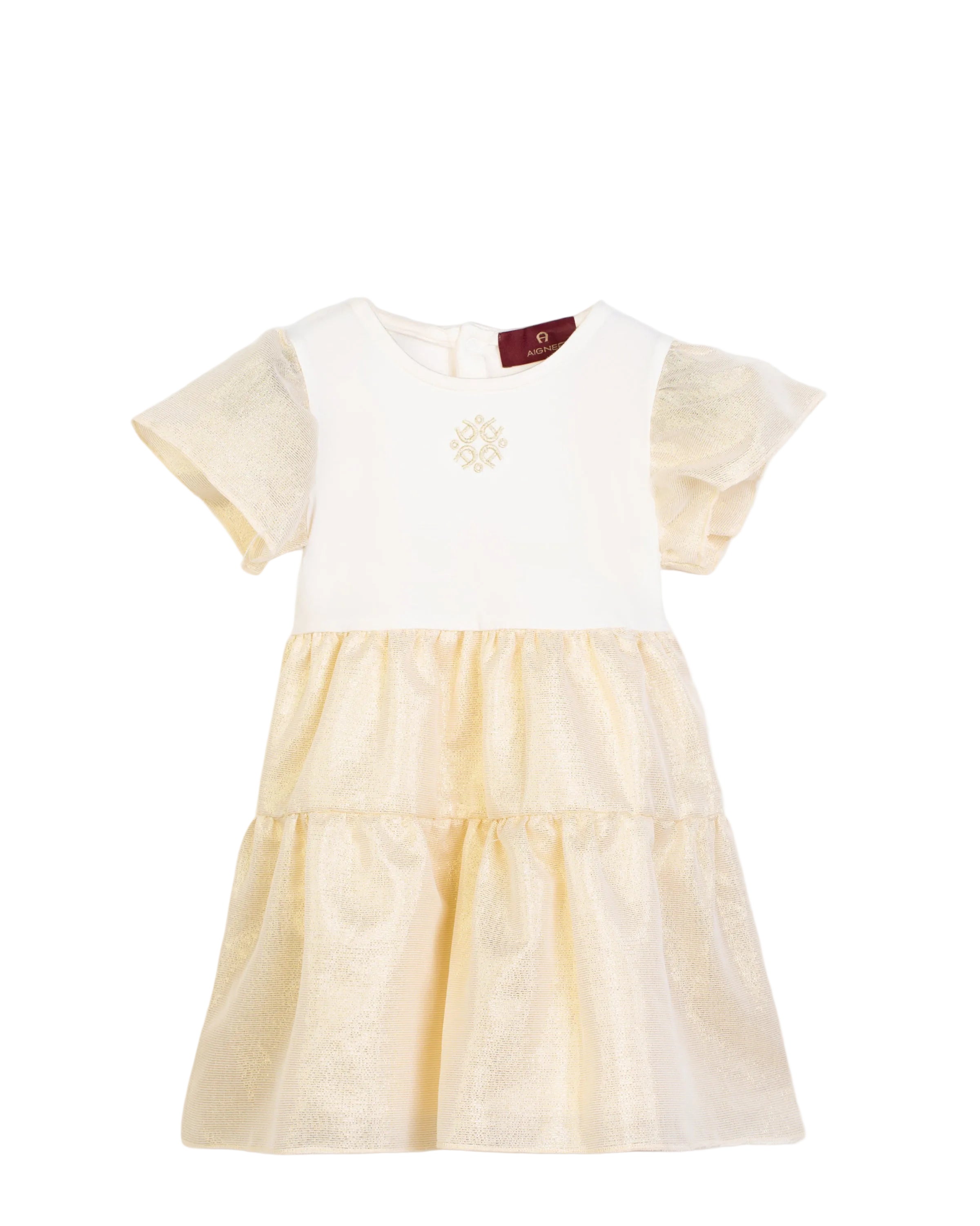 Front view flat-lay studio shot of the Aigner Kids baby girls white and gold dress, highlighting the embroidered geometric logo on the bodice and the sparkling metallic tiered lurex skirt.
