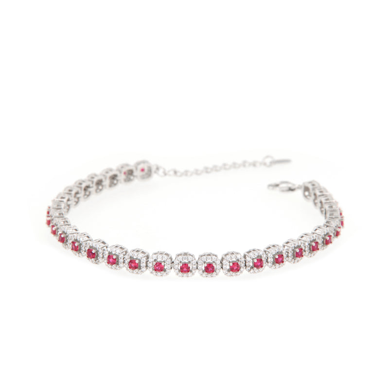 Silver-toned link bracelet featuring square settings with central ruby-red stones surrounded by clear pavé stones.