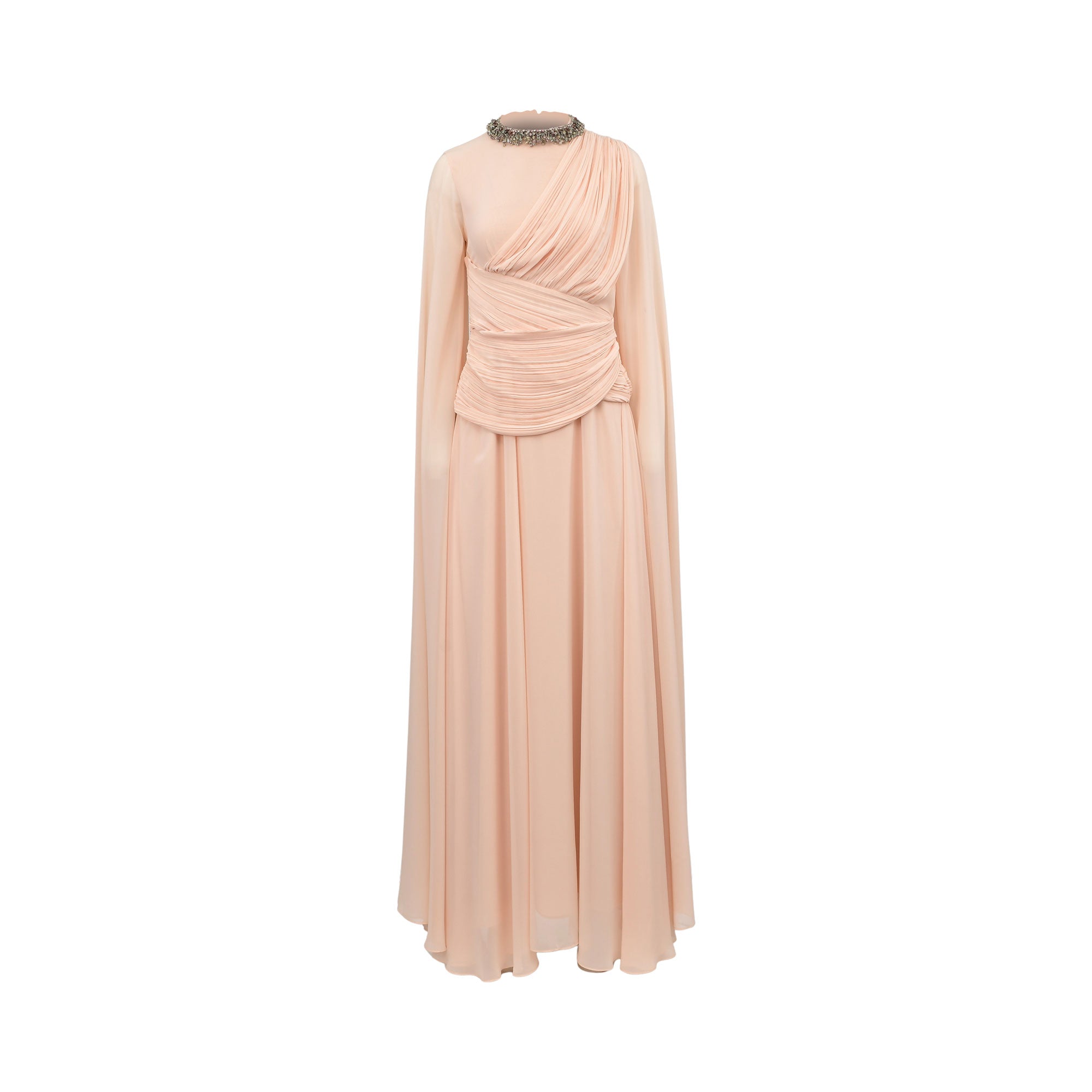 A floor-length draped gown in a soft blush pink color, featuring a high mock neck with a beaded metallic trim, long sleeves, and a gathered twisted detail at the waist, shown against a plain white background.