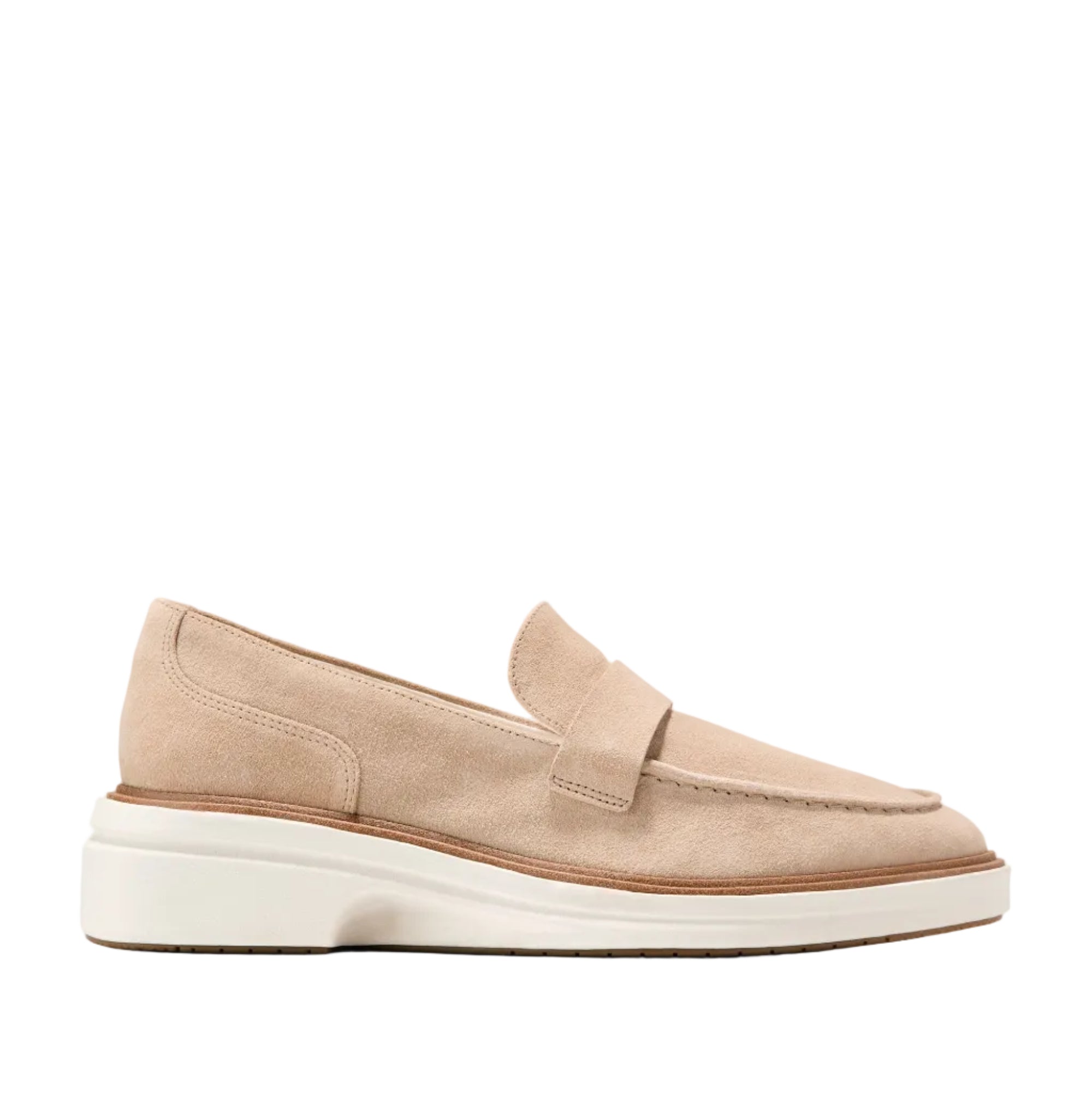 Light beige suede penny loafers with moccasin stitching, a thick white sculpted midsole, and a brown trim.