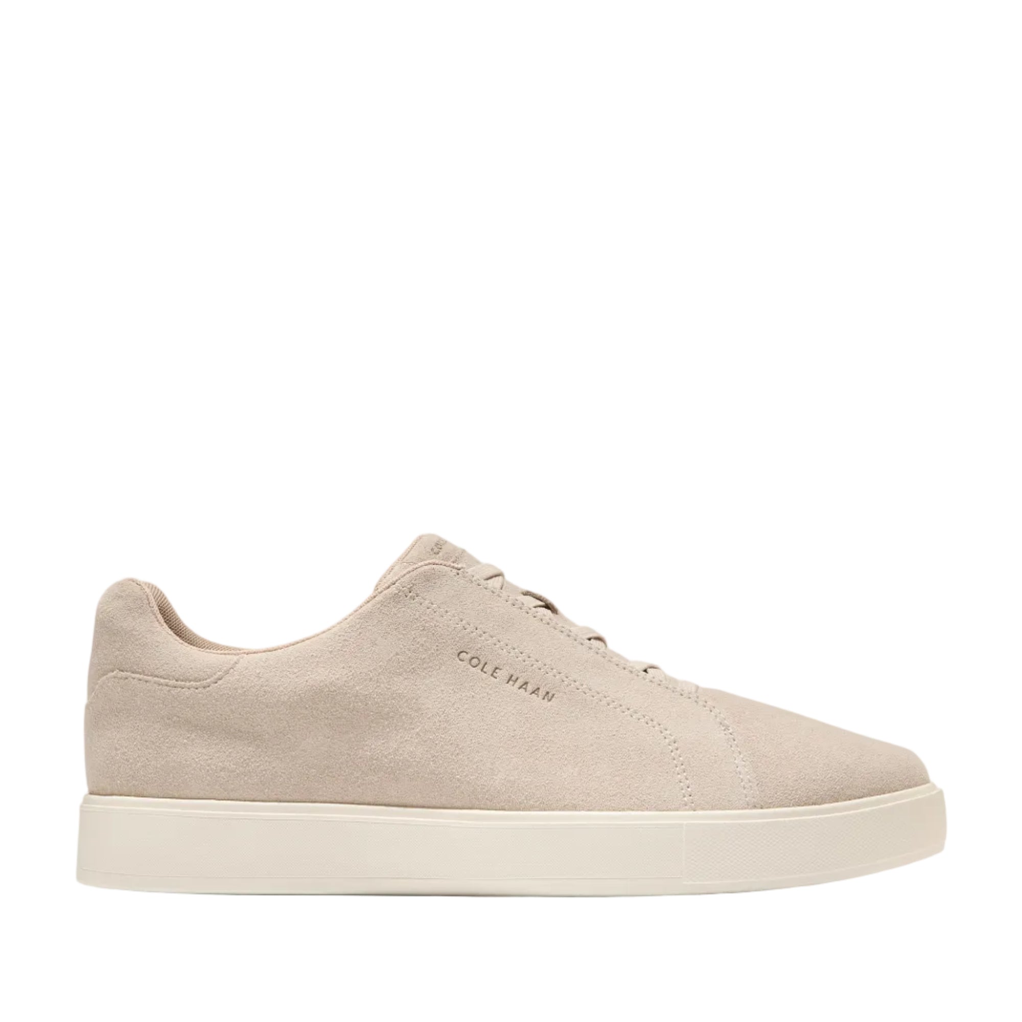 Pale beige suede slip-on sneaker with fixed laces and a thick, off-white platform sole, shown from a side angle.