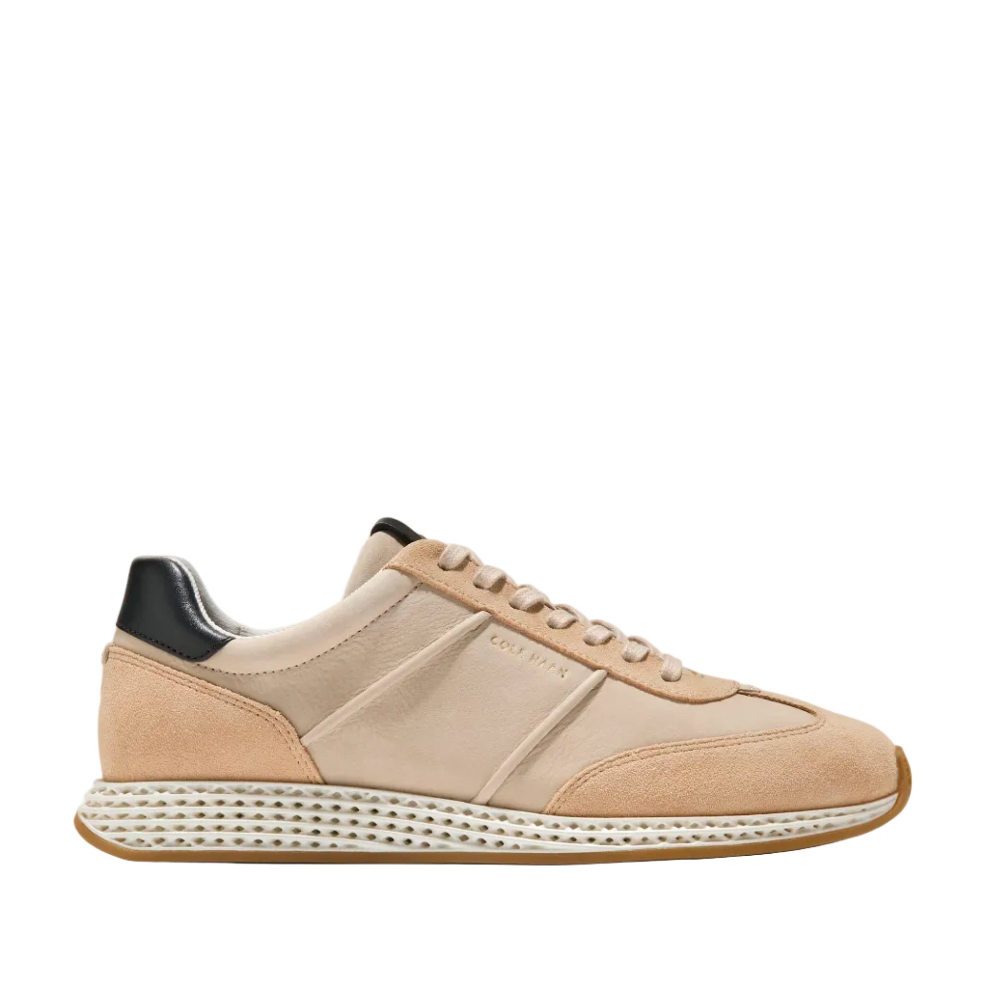 Light beige and peach-toned low-profile sneakers with a black heel tab and textured white midsole.