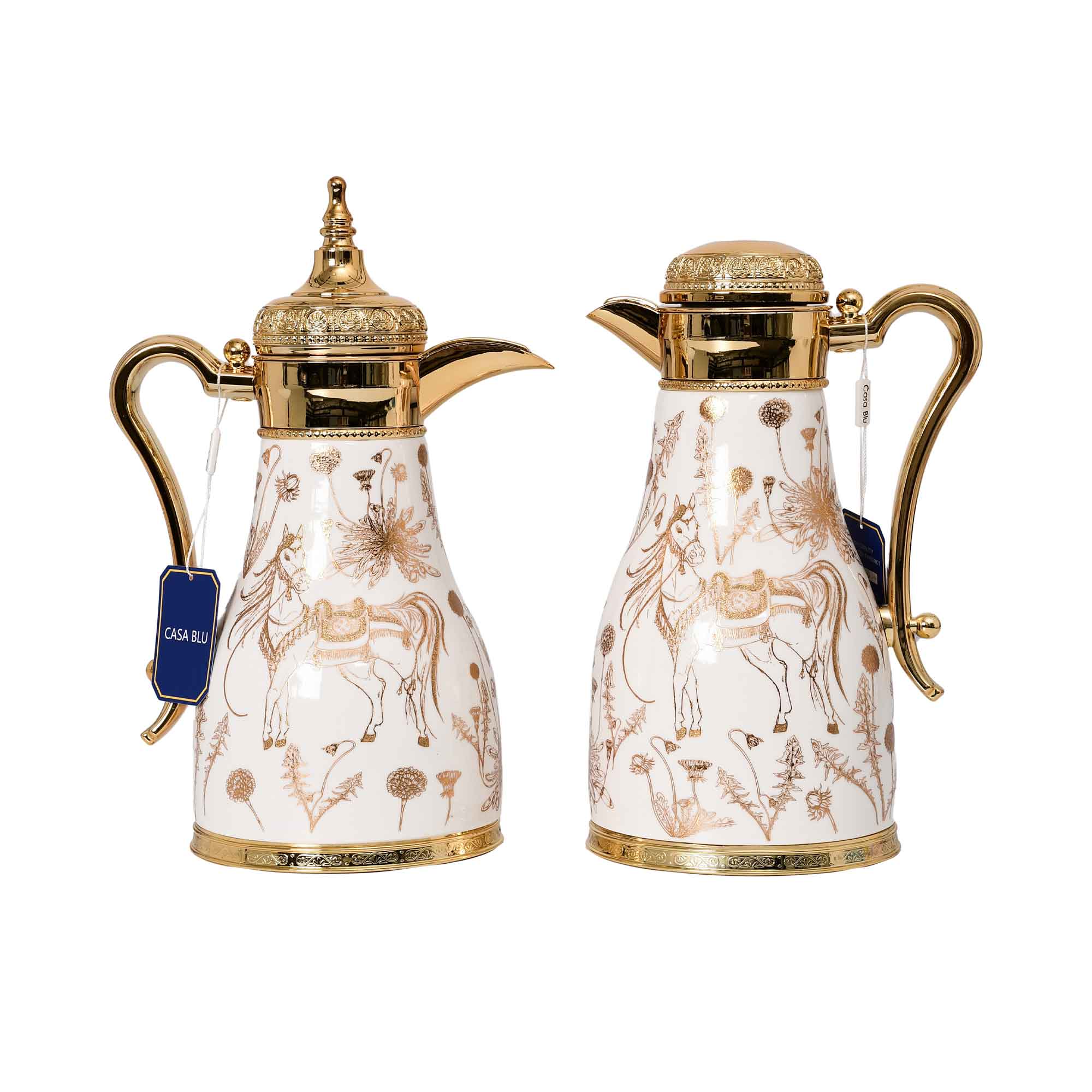 A pair of CASA BLU white and gold thermal coffee carafes (Dallah) featuring golden horse and floral designs with ornate gold lids and handles.