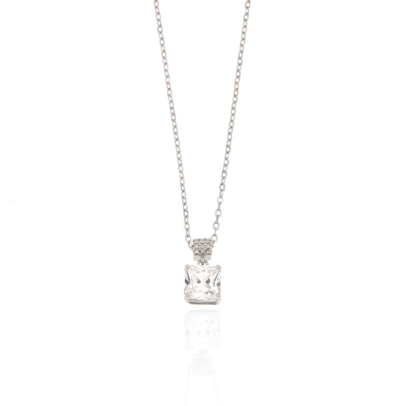 Silver-toned chain necklace with a square-cut clear stone pendant, suspended from a small, embellished bail.