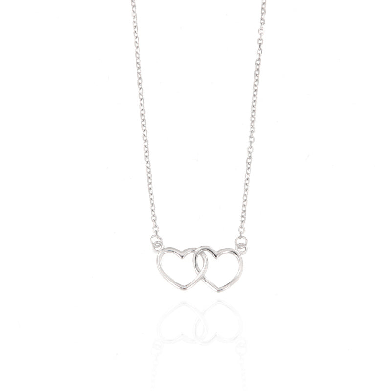 Silver-toned necklace featuring two interlocking heart pendants on a delicate chain with a polished finish.