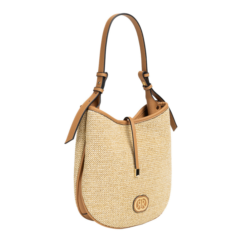 Studio product photograph of the Cerruti 1881 women's Maya shoulder bag, showcasing its natural woven raffia body, tan grained leather strap, central tie closure, and circular gold logo emblem against a plain white background.