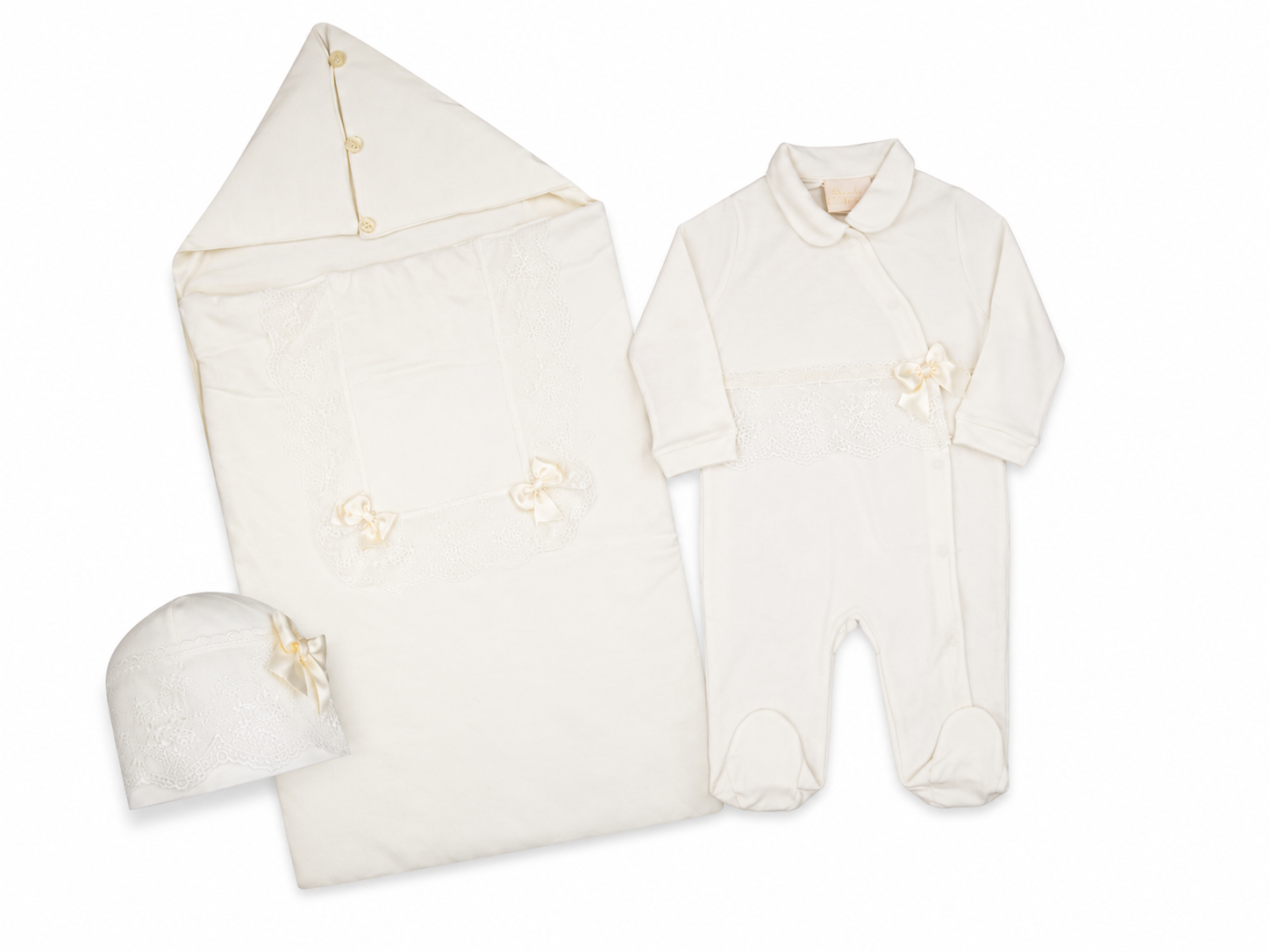 White newborn sleepsuit set including a footed sleepsuit, matching swaddle, and hat, all with lace trim and ribbon bows.