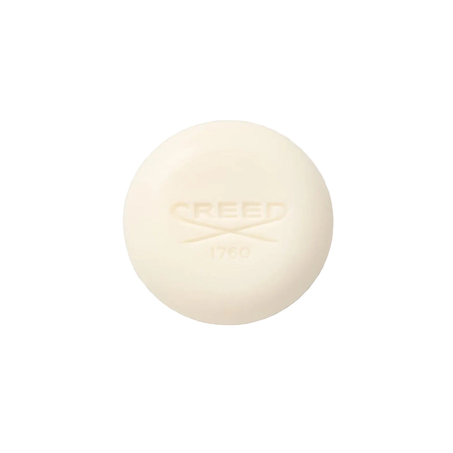 Cream-colored bar of Creed soap on a light gray background.