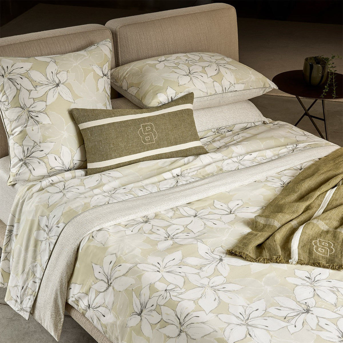 Jadeite green and white floral duvet cover set with a striped cushion and throw blanket, featuring an embroidered logo.