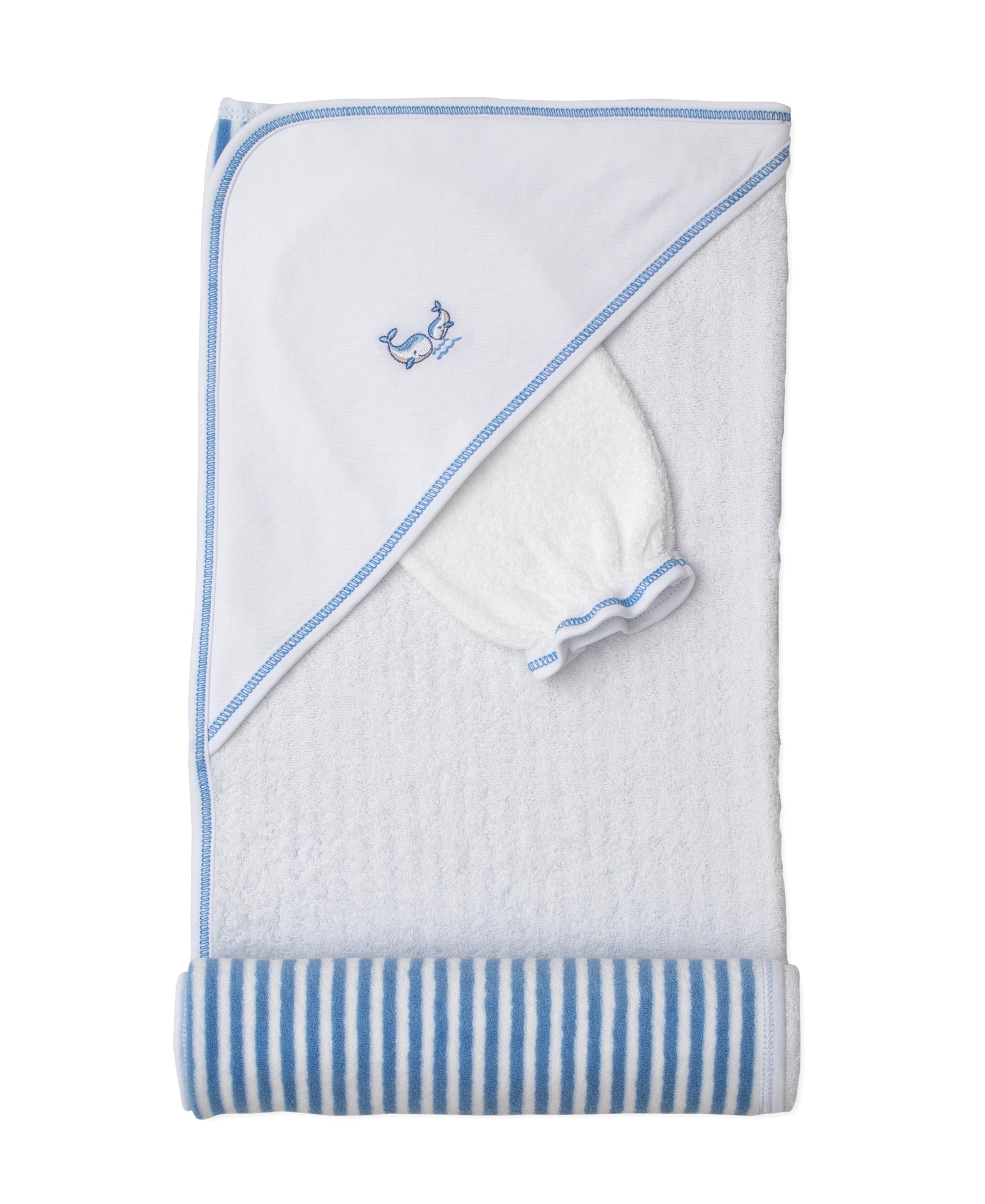 White hooded terry towel with blue trim and embroidered whales, accompanied by a white wash mitt with blue trim.