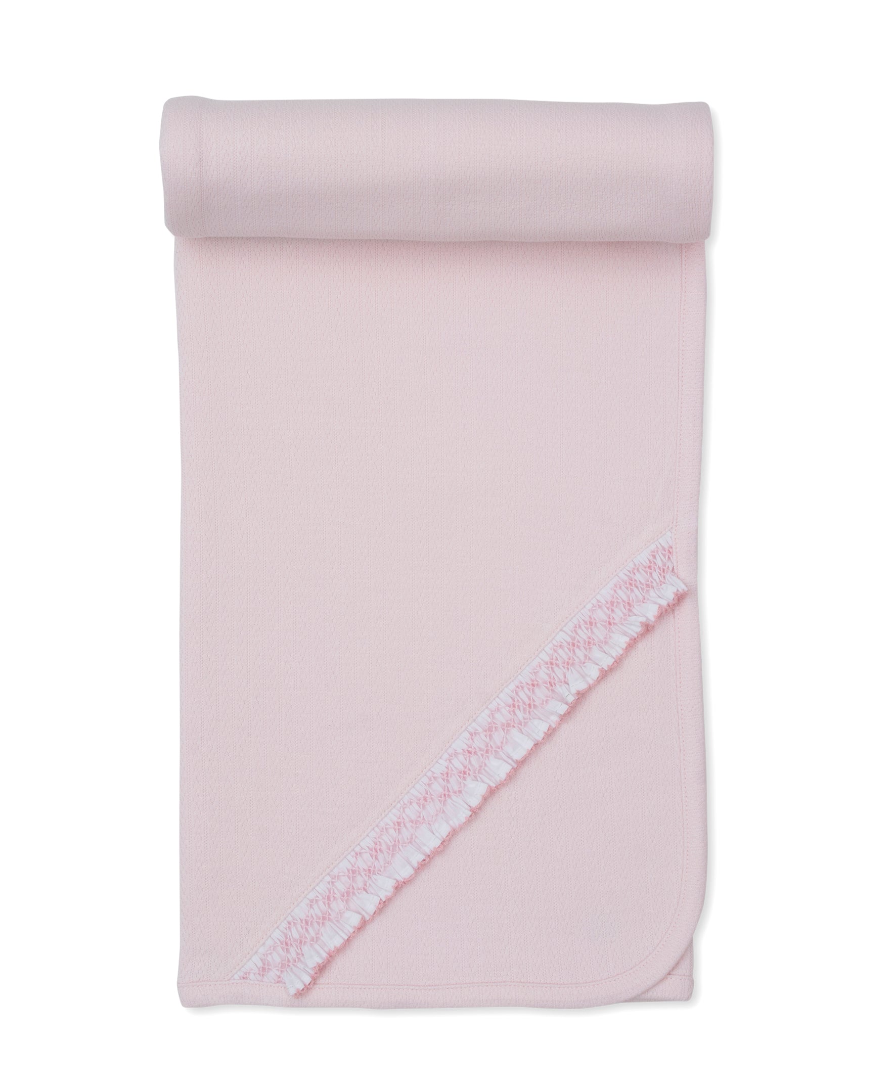 Pink knit baby blanket with rounded corners and a diagonal decorative trim featuring a white and pink patterned ribbon with a