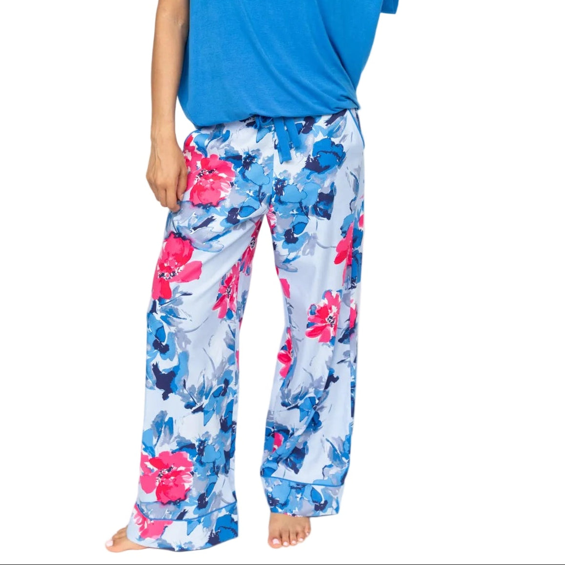 Light blue wide leg pyjama bottoms with a floral print in shades of blue and pink, featuring a drawstring waist and piped hem