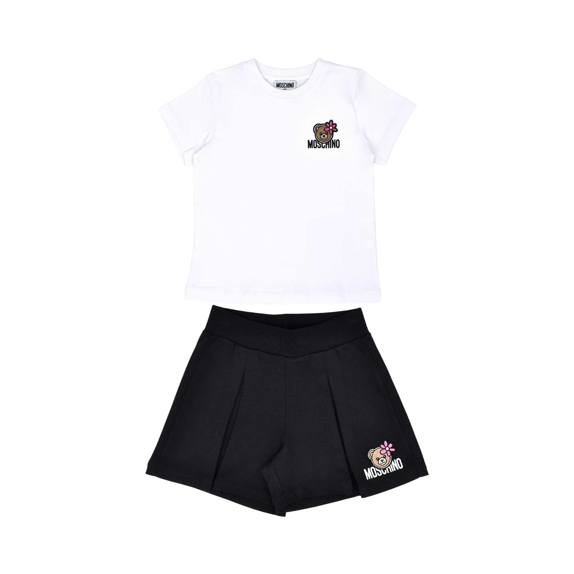 A Moschino Kid two-piece set including a white short-sleeved T-shirt and black pleated shorts, both featuring a Toy Bear logo.