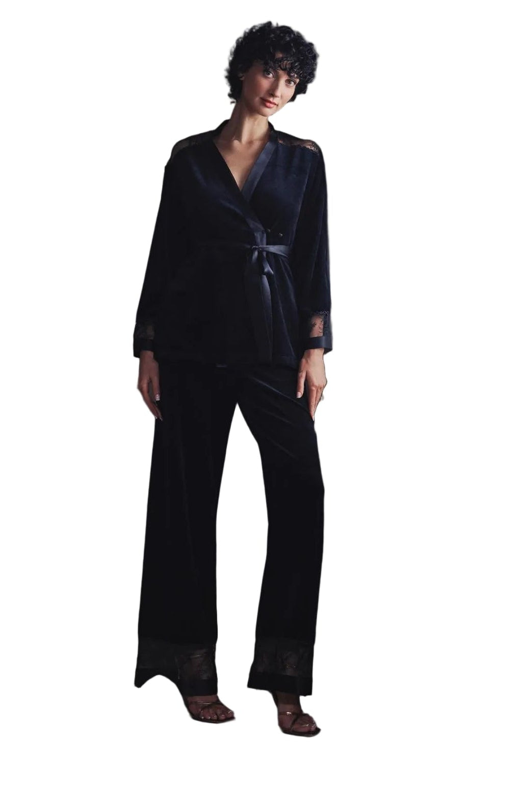 Model wearing Marjolaine dark velvet wrap jacket sitting by window available at BLUE SALON
