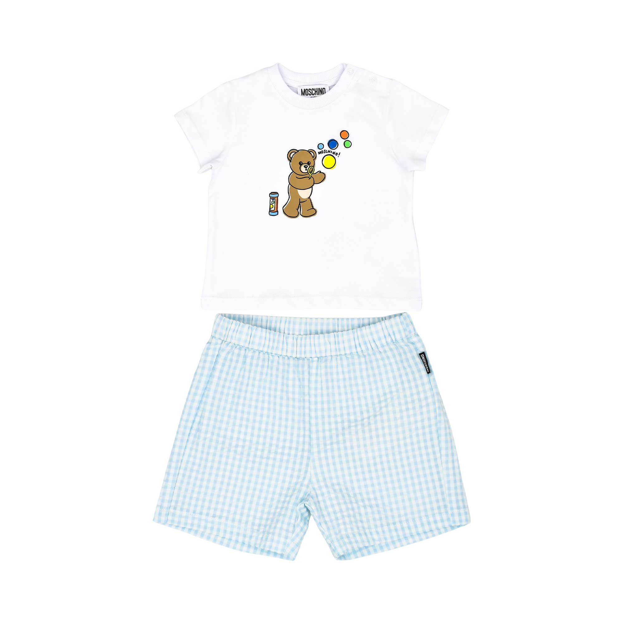 A baby's two-piece designer set featuring a white T-shirt with a teddy bear blowing bubbles and light blue gingham checkered shorts.