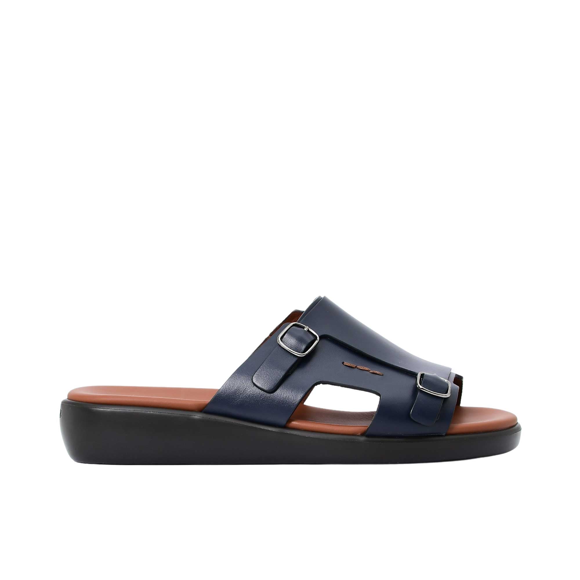 Profile view of a navy PRESTIGE leather sandal highlighting the thick black ergonomic sole and buckle detail.