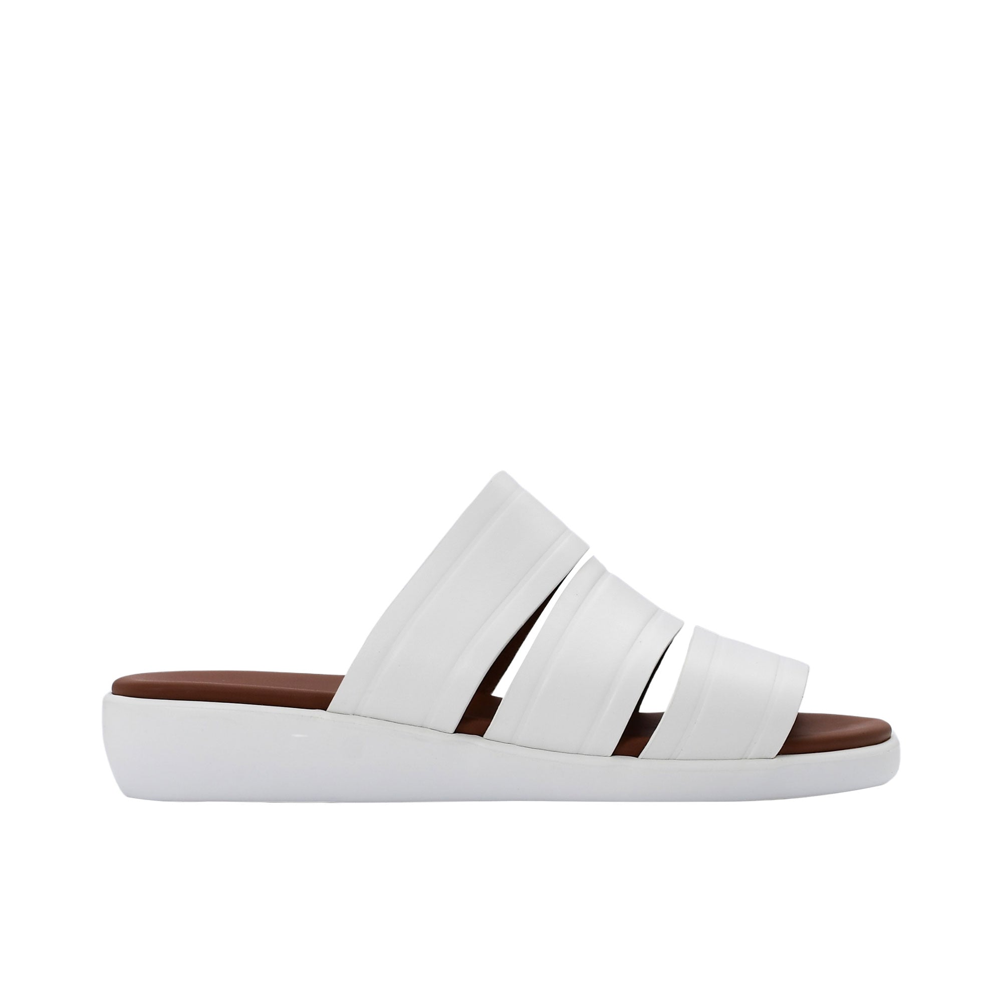 Side profile of PRESTIGE white leather slide sandals showing the thick black sole and tan footbed.