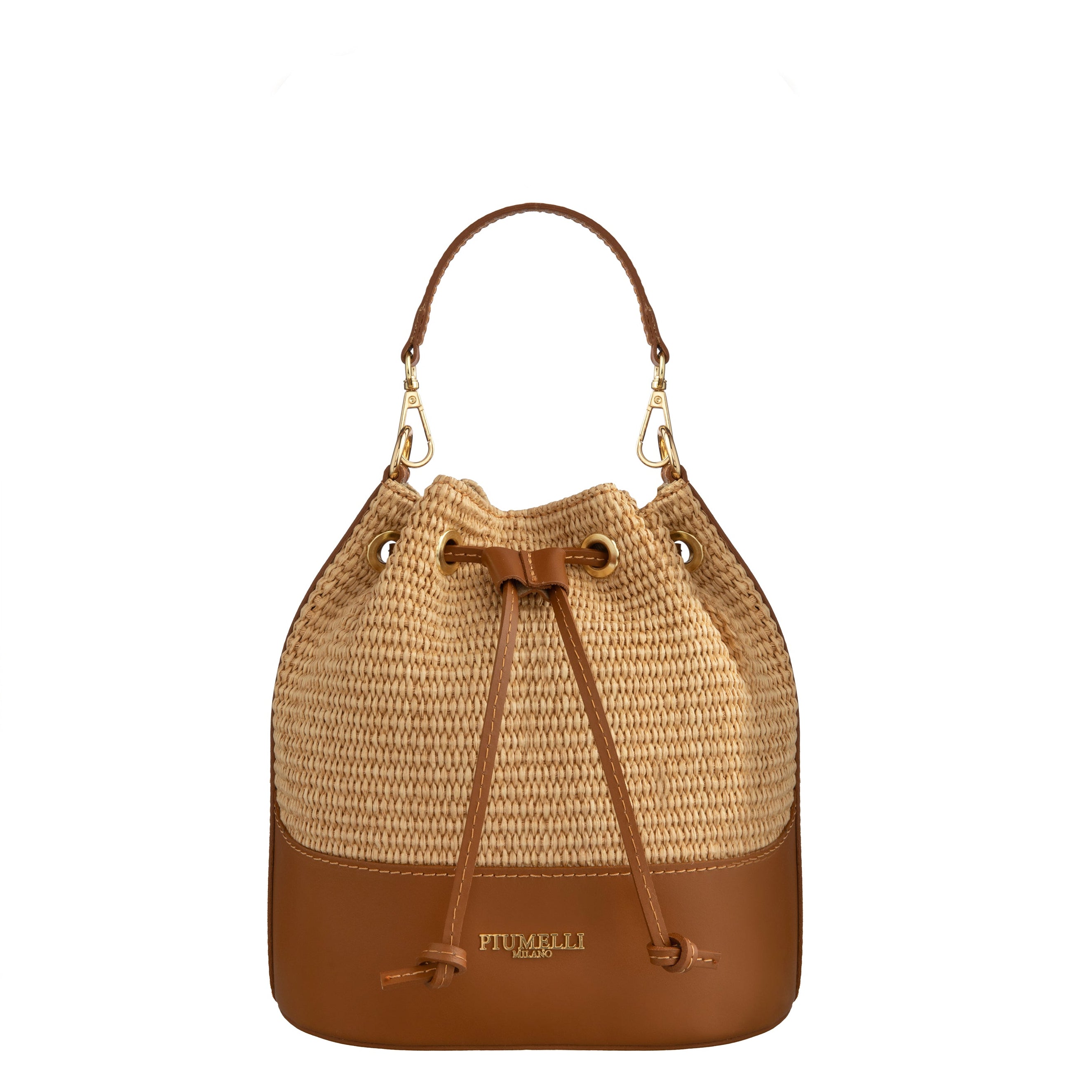 Piumelli Meg Tobacco bucket bag in woven straw and leather with gold hardware and drawstring closure. Available for Online Purchase