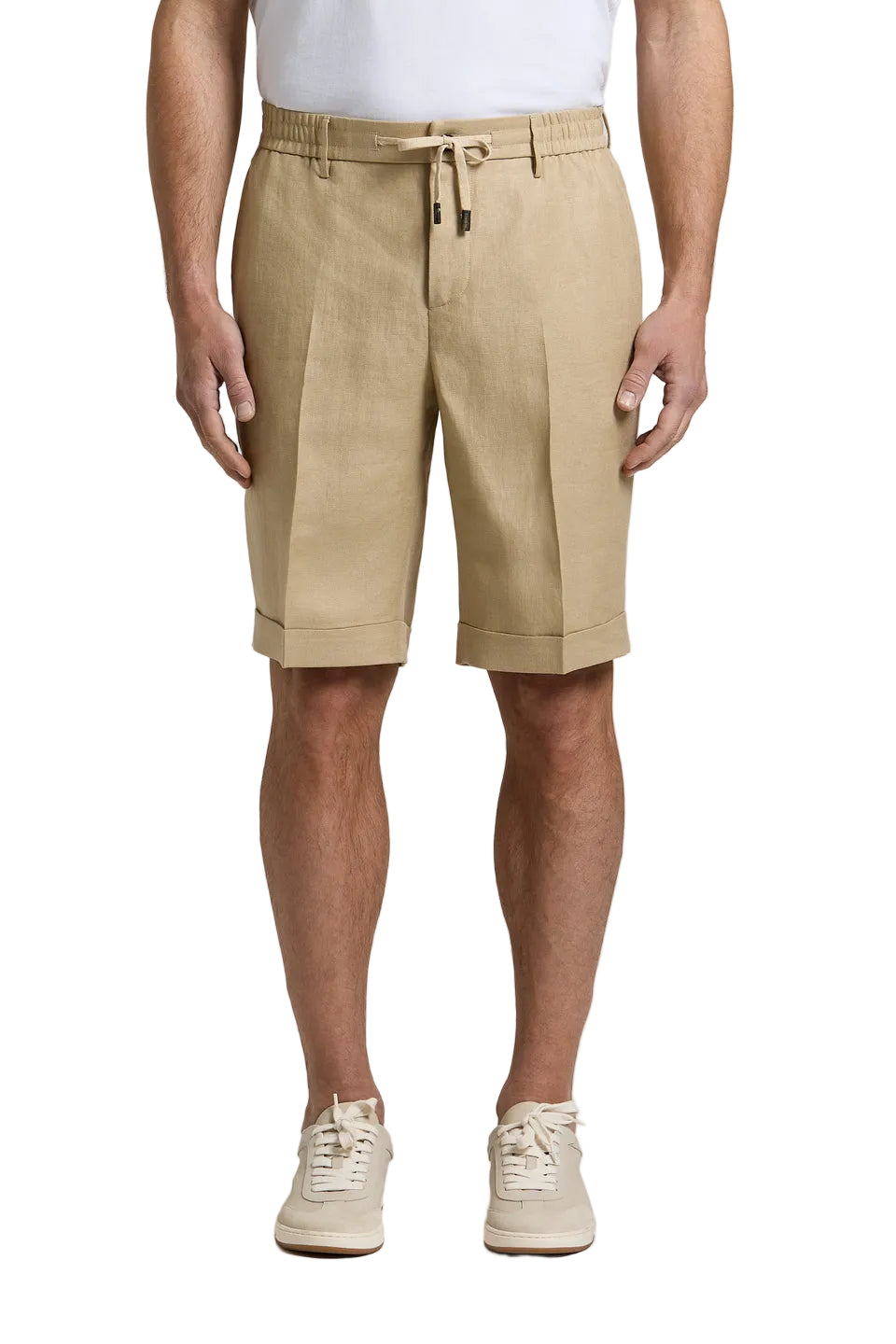 Light brown pure linen gabardine shorts with front pleats, elasticated drawstring waistband, and cuffed hems.