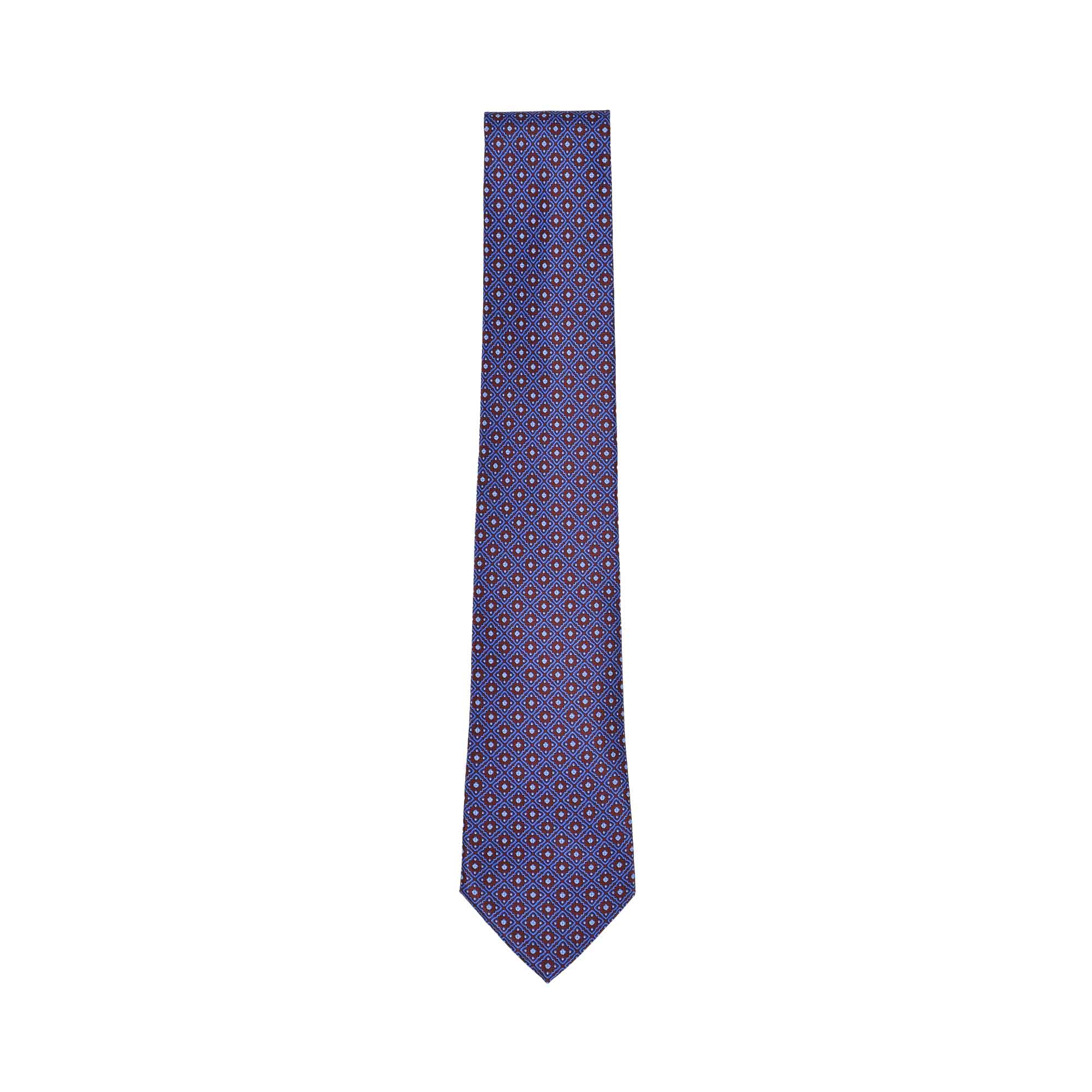 A blue necktie with a repeating geometric pattern of small squares and red-centred dots, tapering to a pointed end.