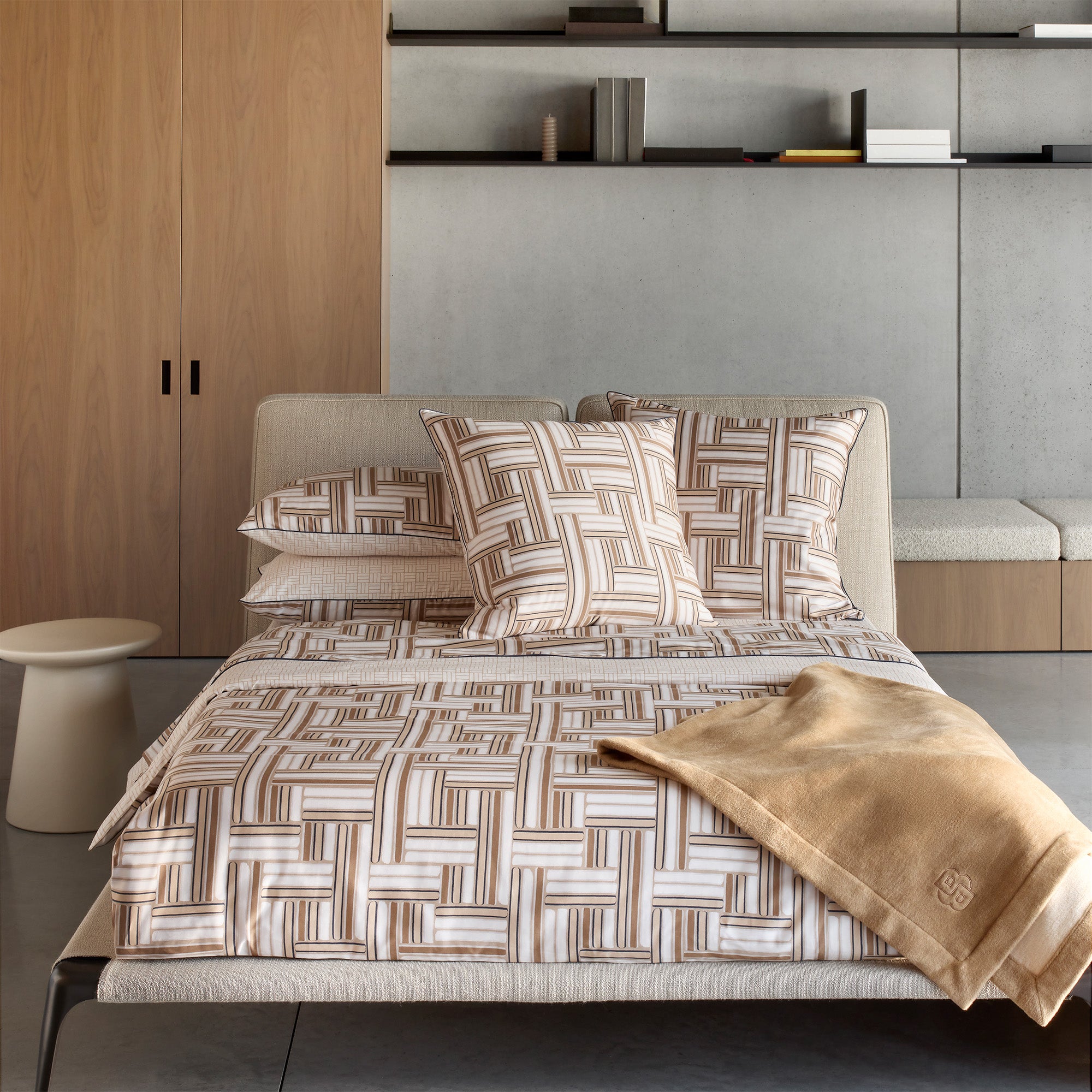 A duvet cover set with a brown and off-white geometric interlocking pattern, including a duvet cover and two pillowcases, on