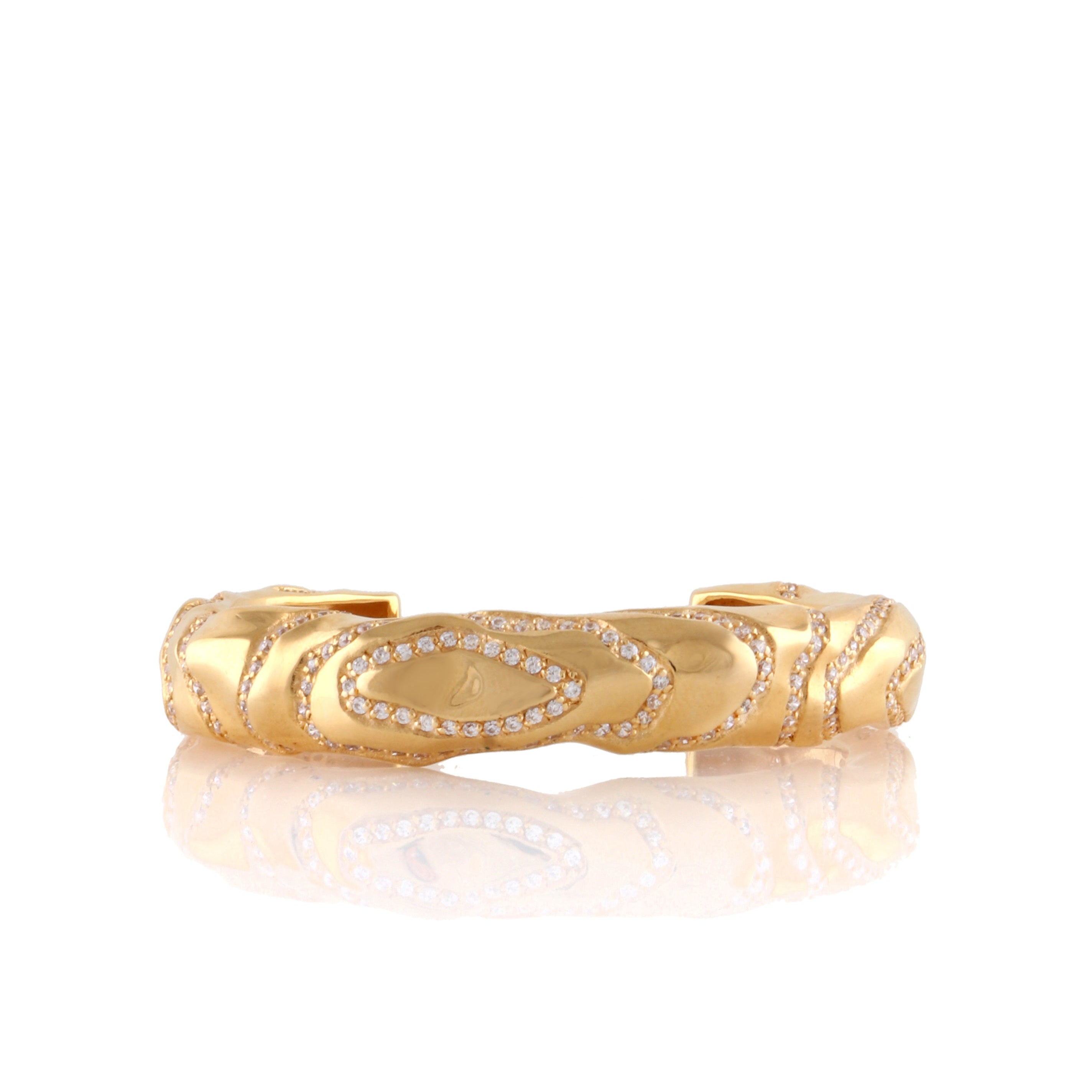 Gold-toned wavy cuff bangle with handset clear stones in elongated oval patterns.