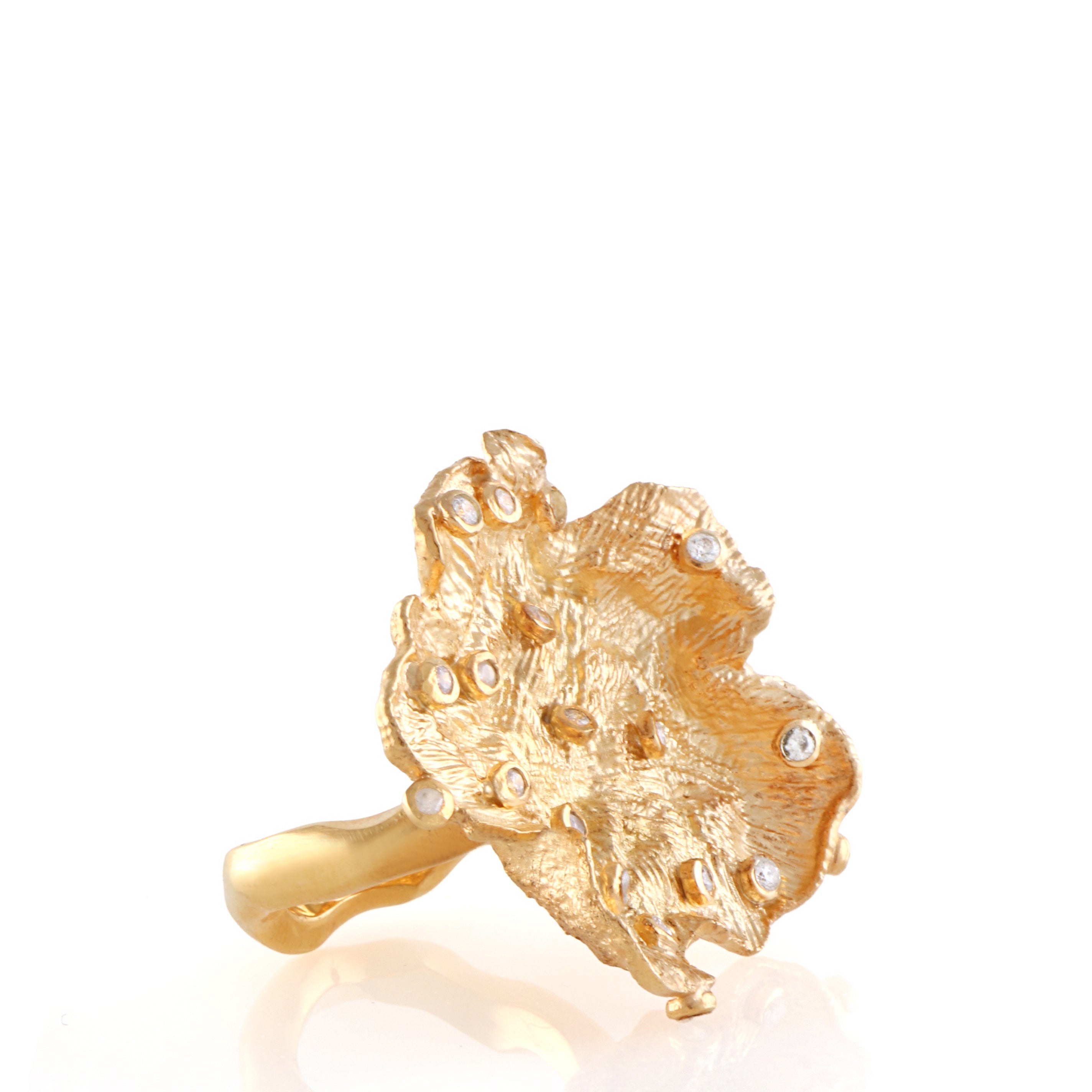 Gold-toned statement ring with an organic, textured flower-like top embellished with scattered clear stones.