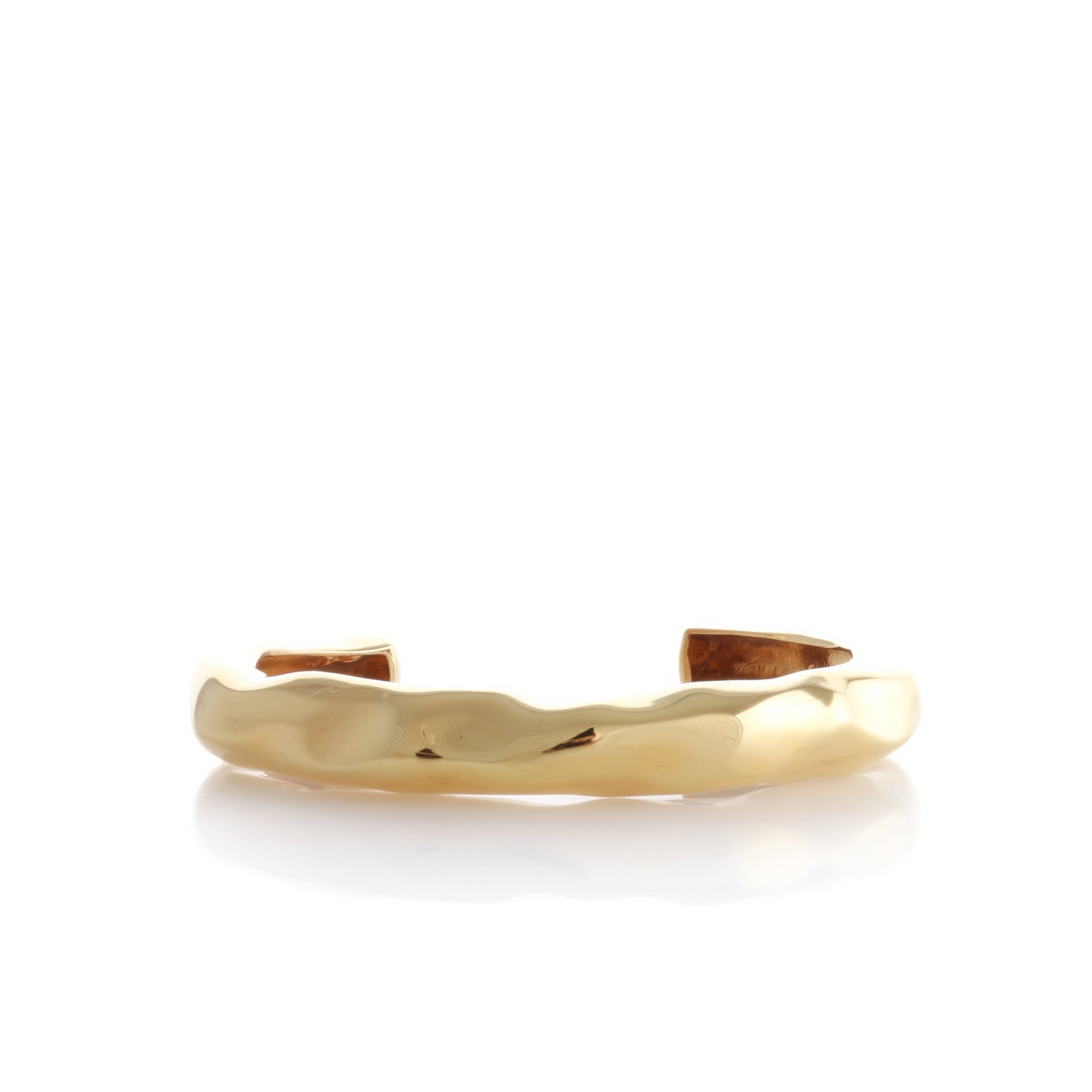 Gold-toned open cuff bracelet with a wide band and an irregular, hammered, wave-like surface texture.