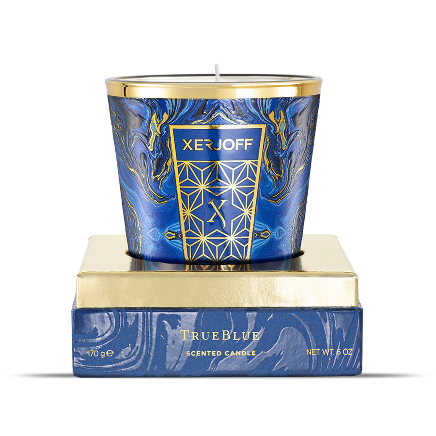 The Xerjoff TrueBlue 170g scented candle displayed on its gold and blue base. The glass features a deep blue marbled design with a gold crest and rim.