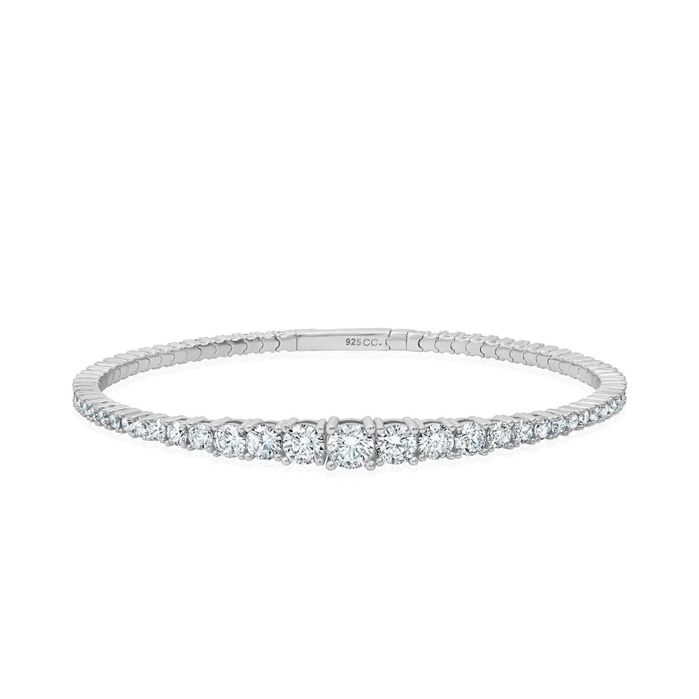 Silver-toned stretch cuff bracelet with a continuous line of clear, round, graduated cubic zirconia stones.