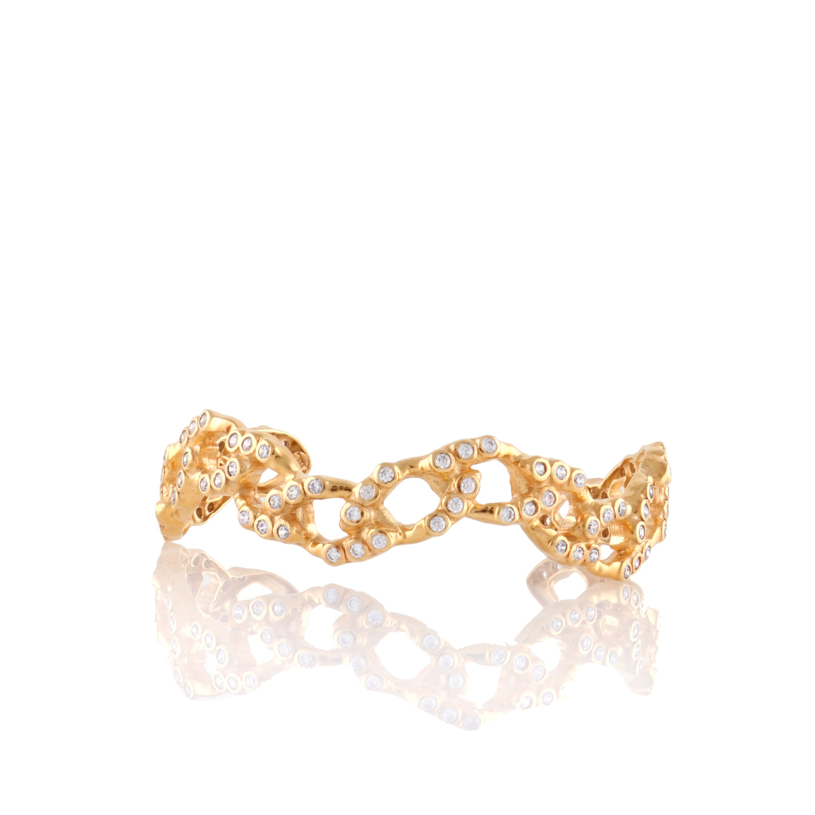Gold-toned wave chain cuff bracelet with a textured finish and numerous clear handset stones.