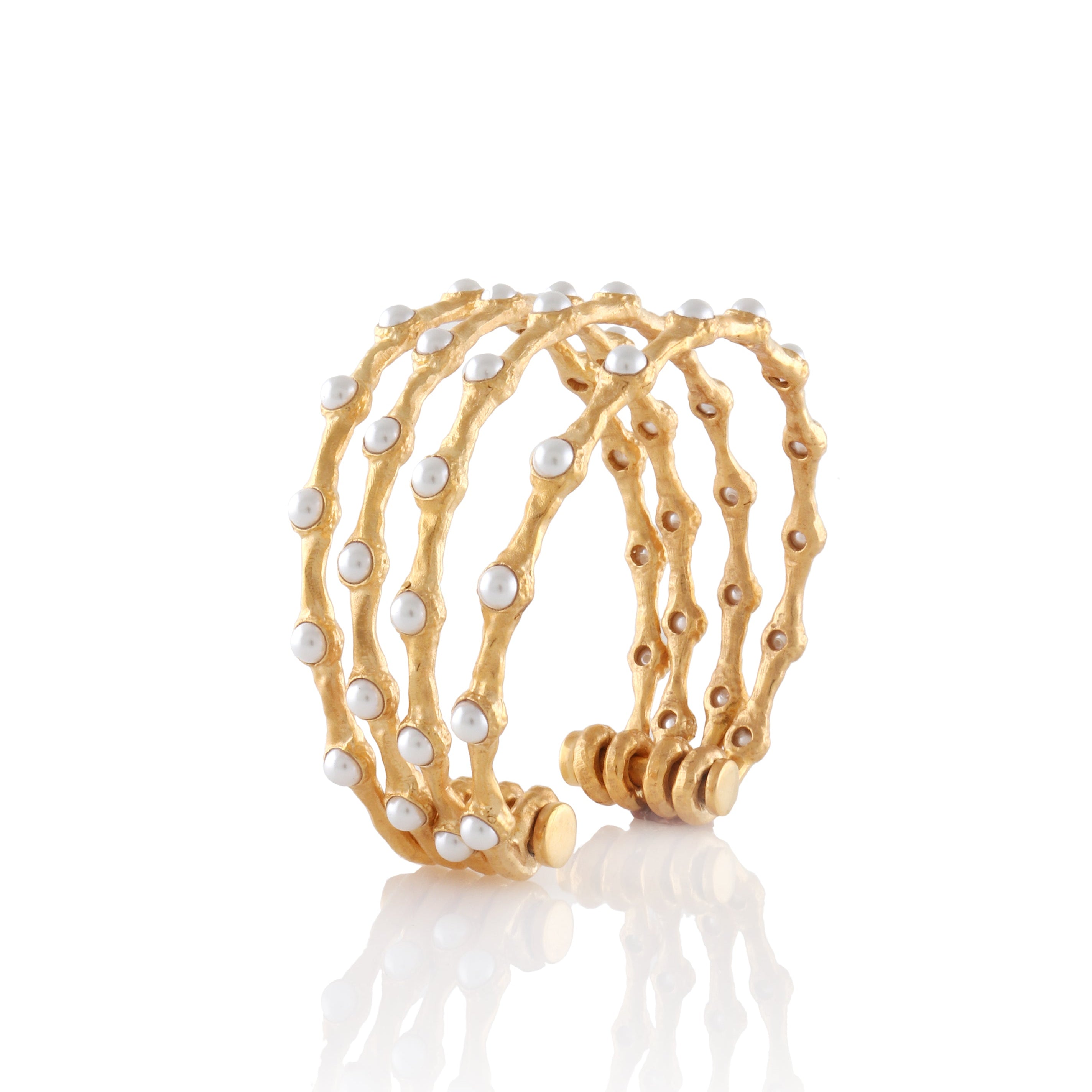 Gold-toned multi-band wave cuff bracelet with white pearl embellishments and an open back.