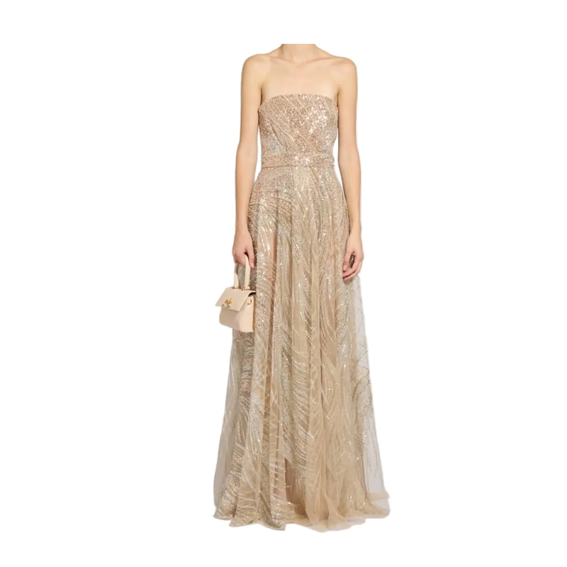 Beige strapless gown with sequin top on a white background