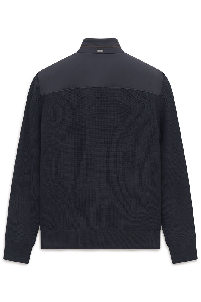 Navy blue ribbed knit cardigan, back view, with a smooth upper back panel, stand-up collar with a brown stripe, and a silver-