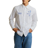 Optic white long-sleeved collared shirt with blue embroidered logos on the chest.