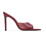 Single chili flake red leather high heel mule with an open toe and a slender stiletto heel.