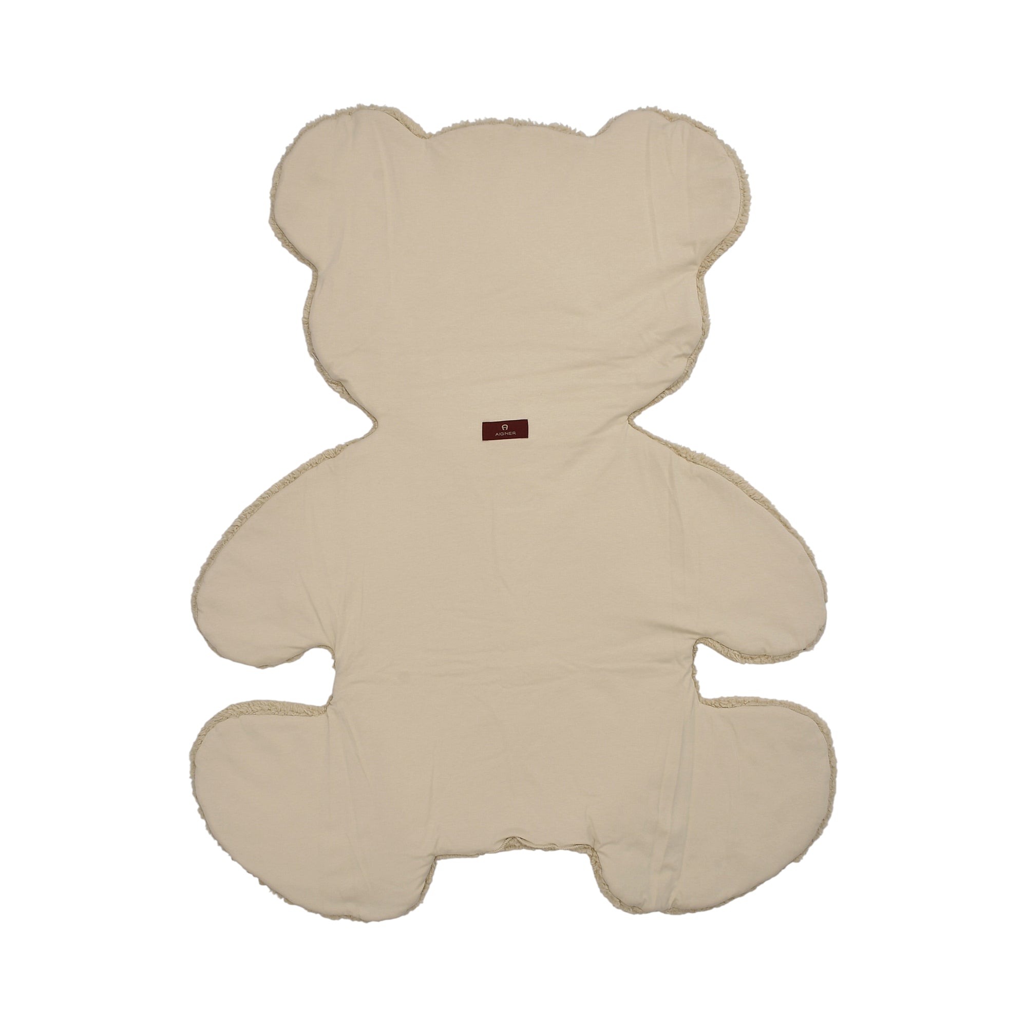 Cream teddy bear-shaped blanket with a smooth surface and fluffy trim. Small brown logo label.