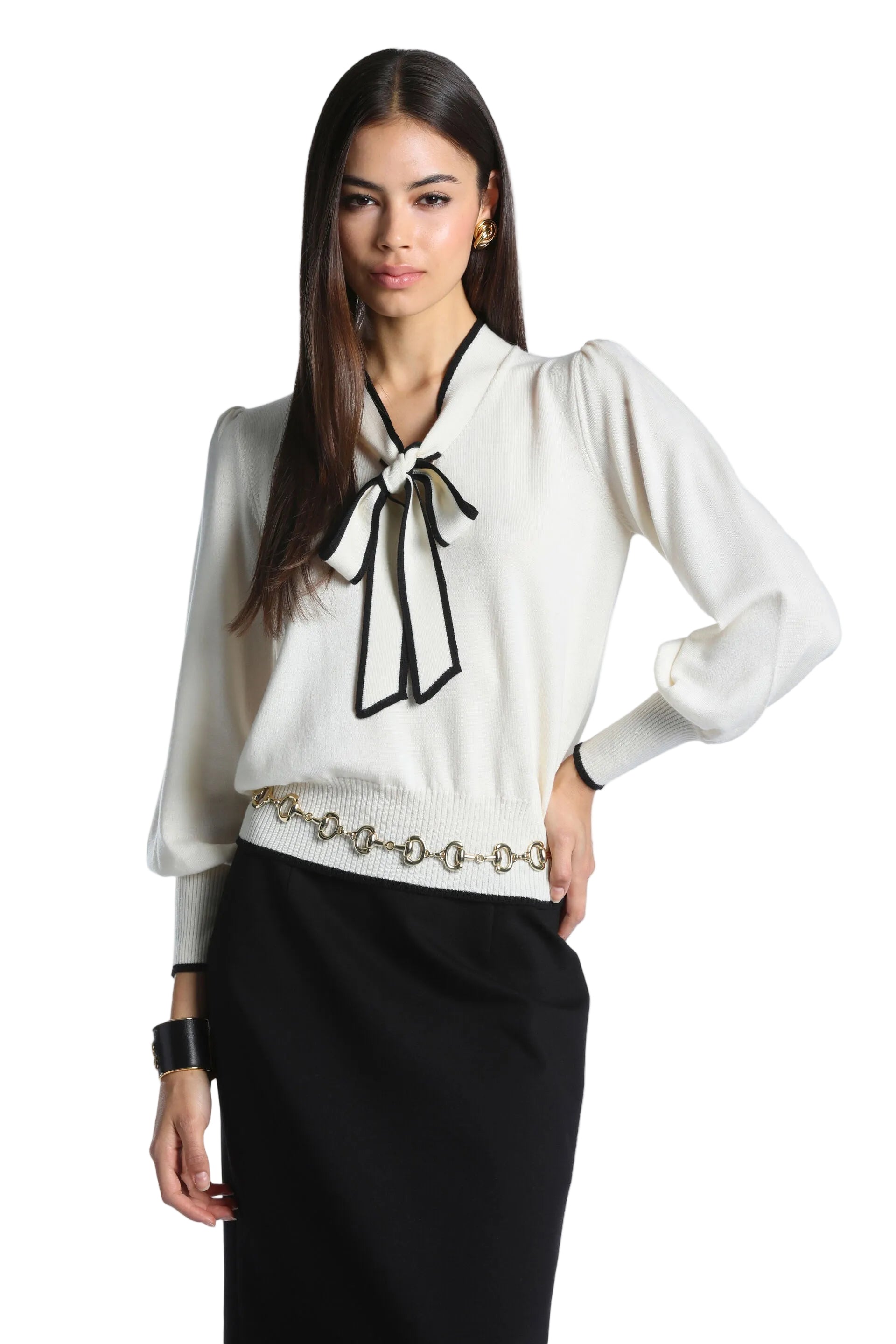 Cream knit pullover with a black pussy-bow neckline and black contrasting trim on the collar, cuffs, and hem.