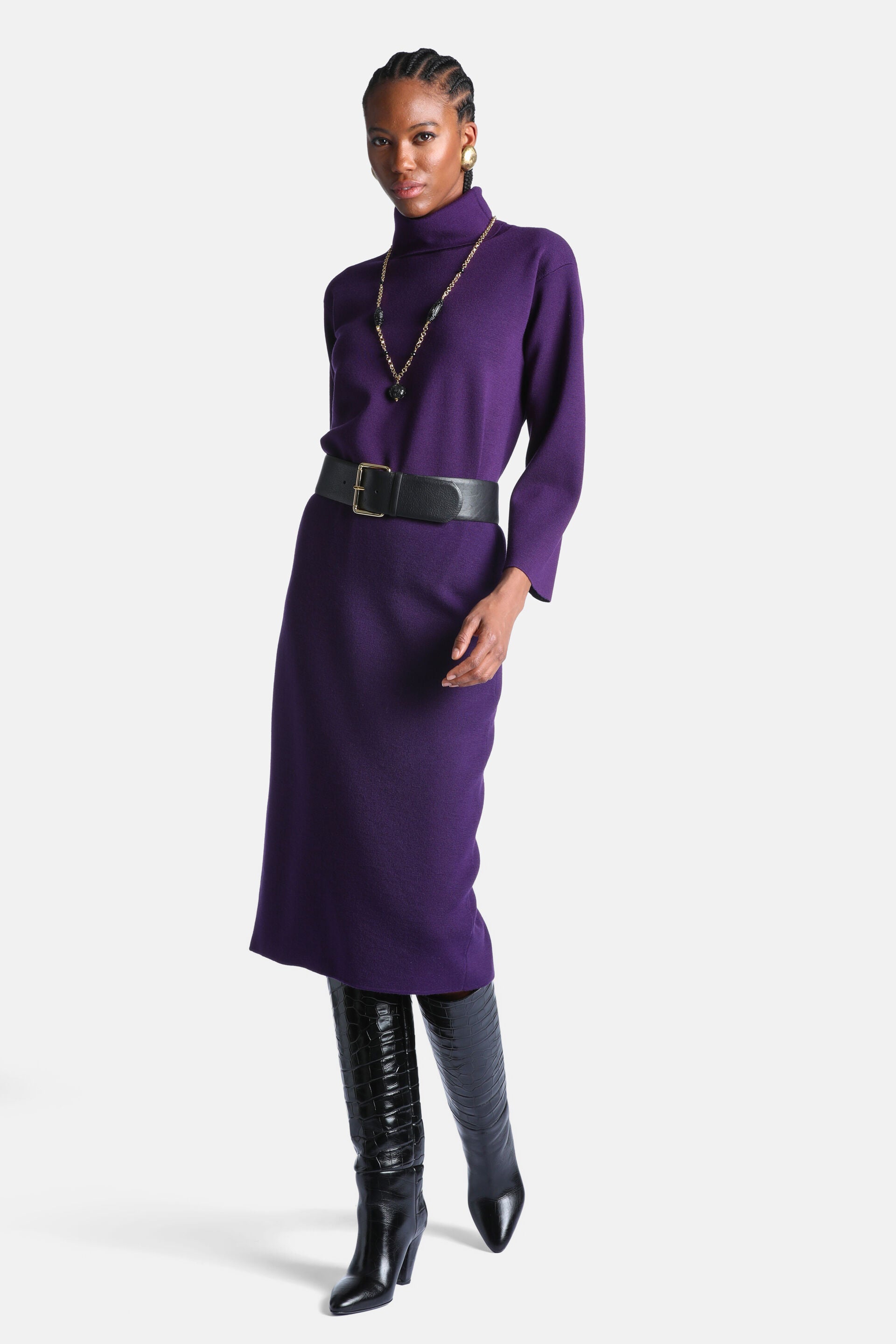 Deep purple knit turtleneck tunic dress with long sleeves and a straight midi-length skirt.