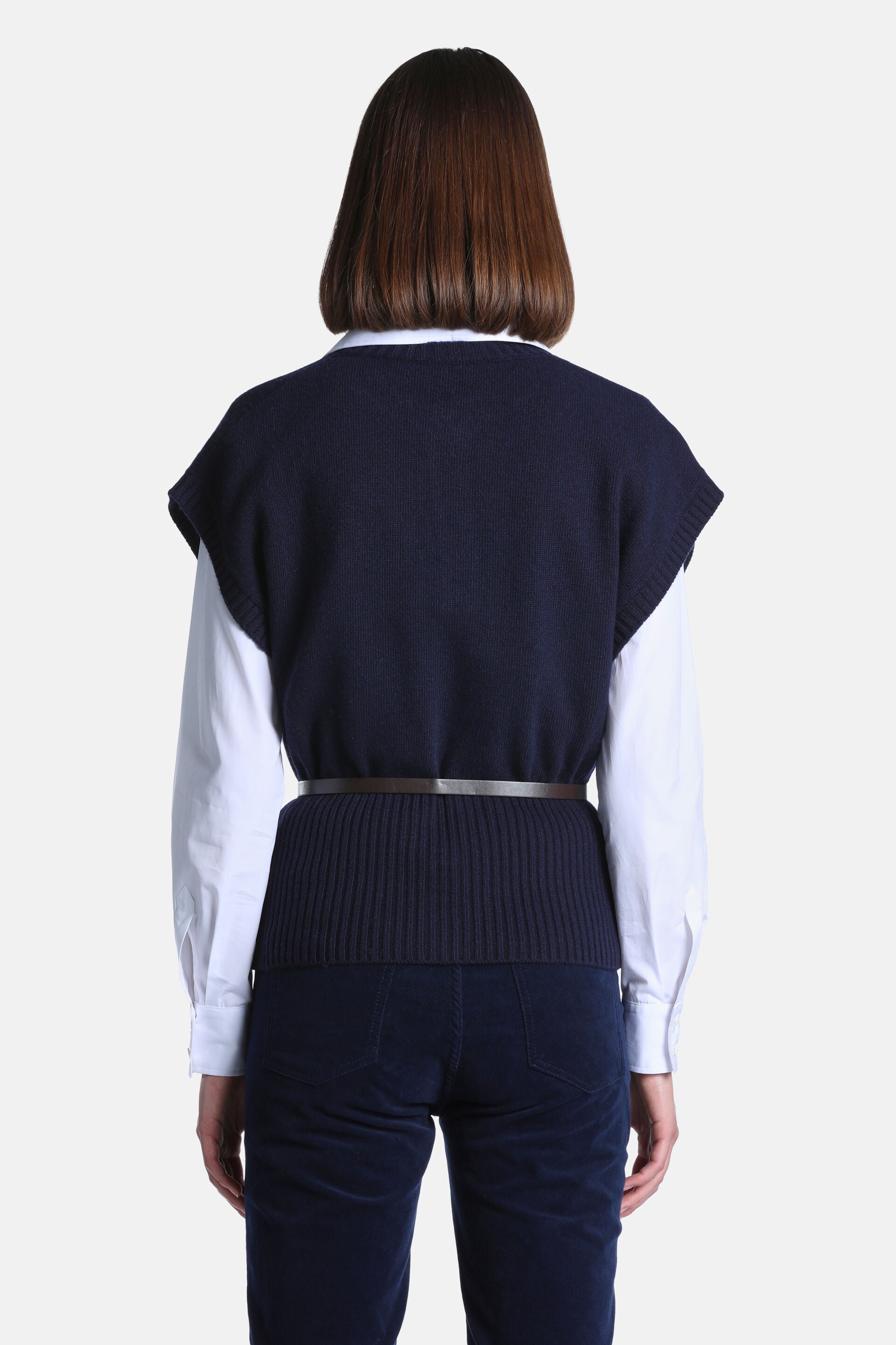 Navy blue knitted sleeveless waistcoat, seen from the back. It has a rounded back neckline, a fine knit body, and a ribbed he