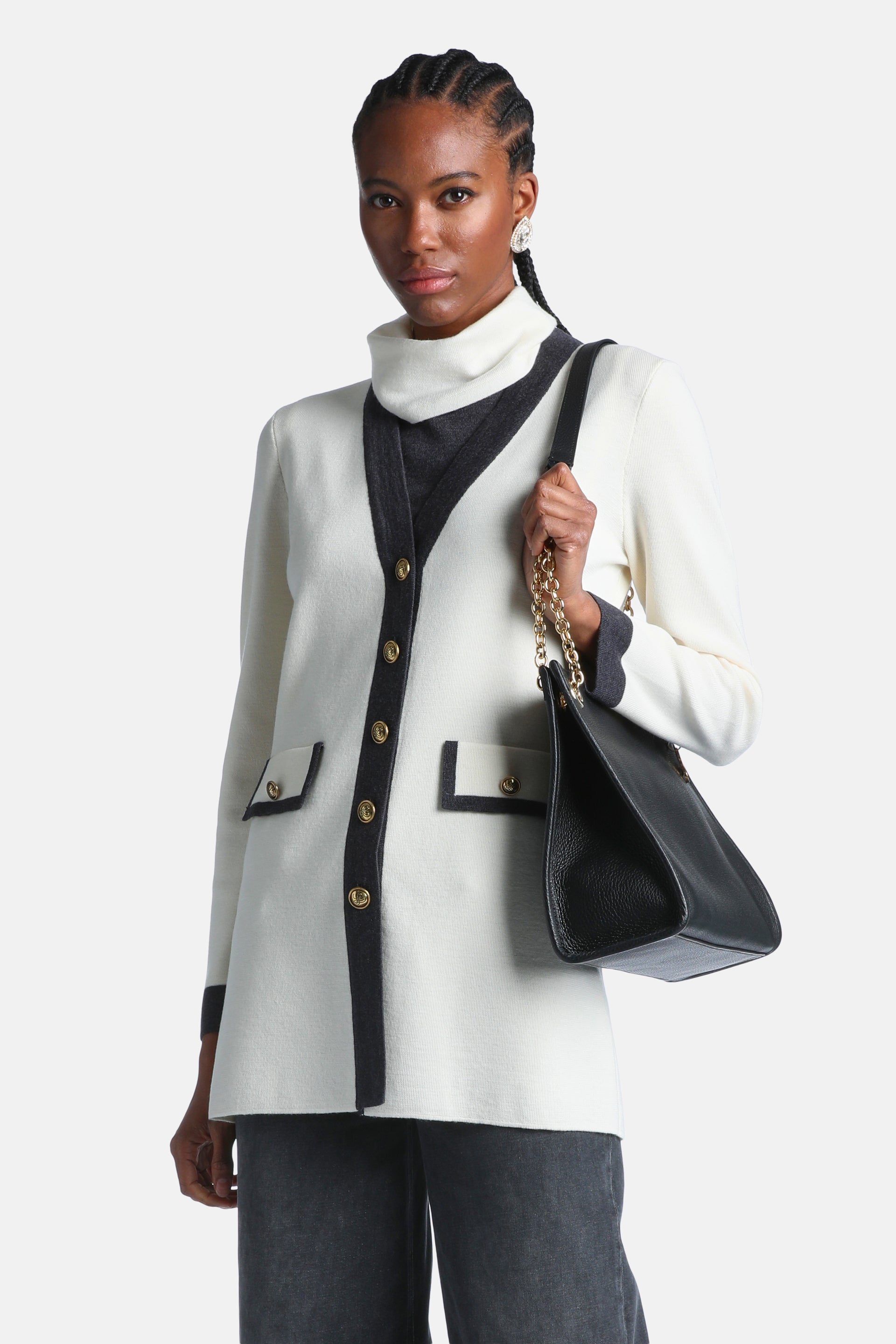 Off-white knit cardigan with dark grey trim along the V-neck, front, cuffs, and two patch pockets. Features gold-toned button