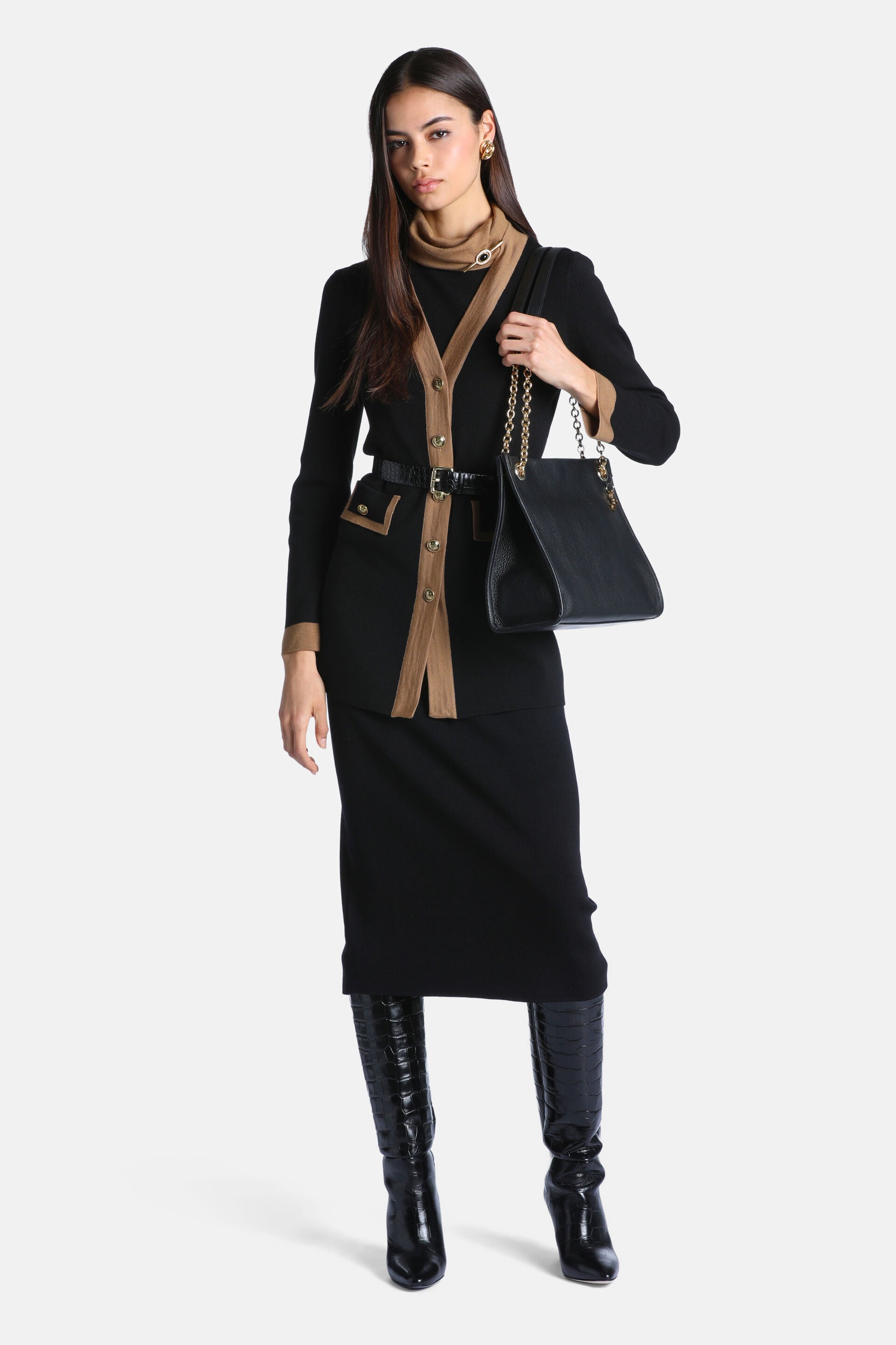 Black knit cardigan with camel trim along the V-neck, front, and cuffs. Features gold-toned buttons and two patch pockets.